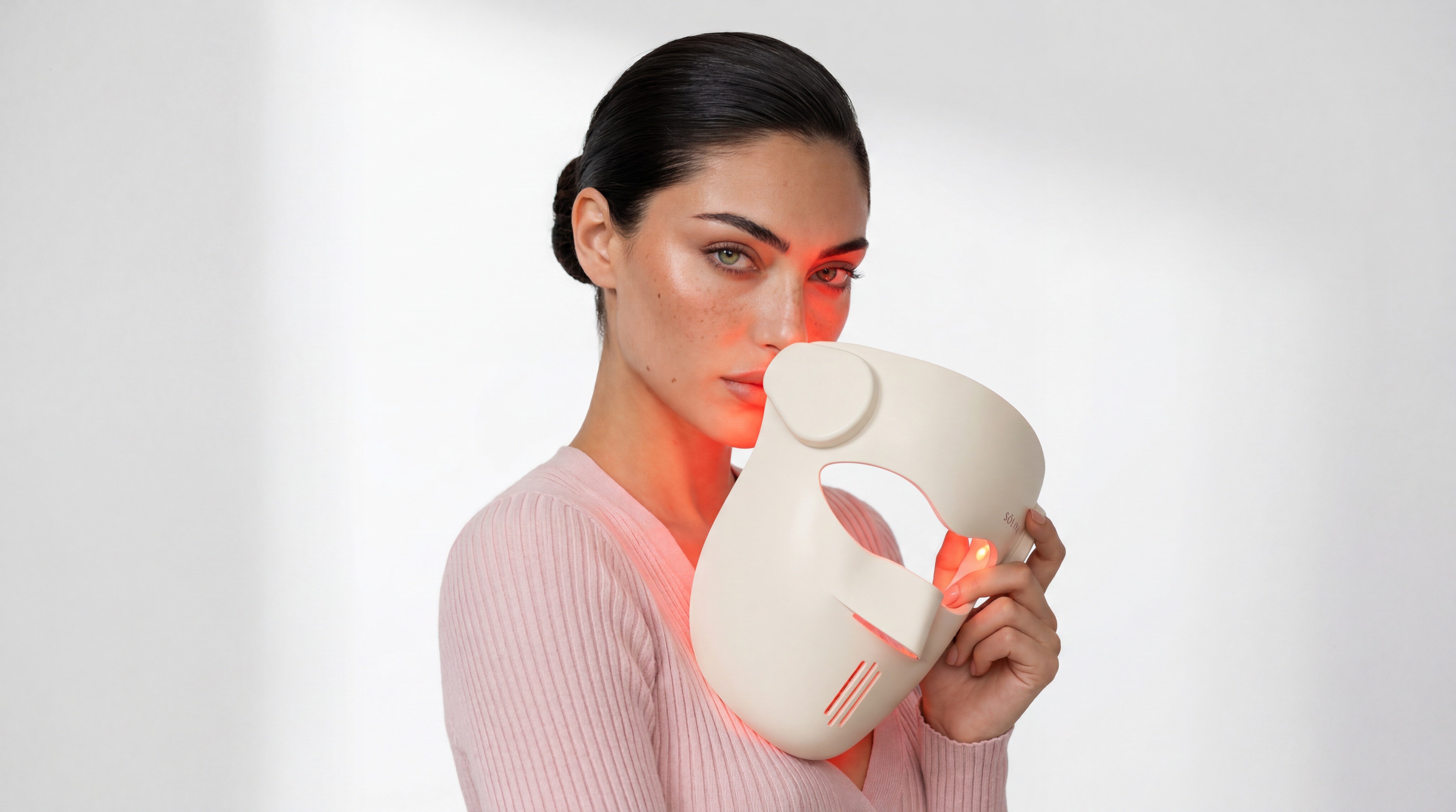 Woman holding LED mask