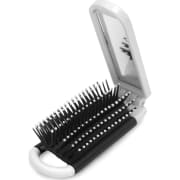Espejo de maquillaje con cepillo plegable.