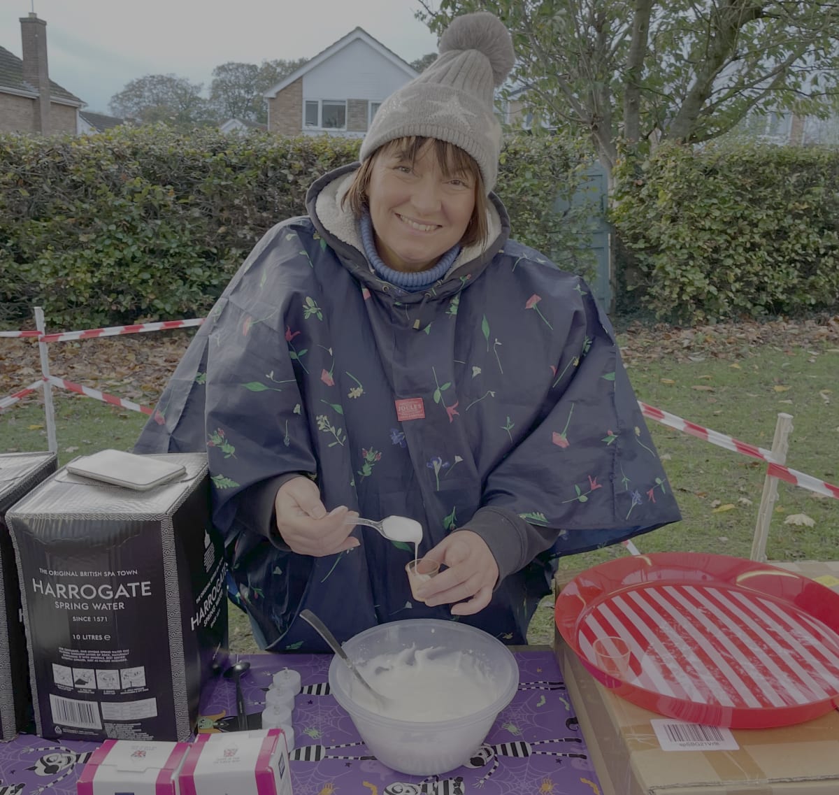 A community team member helping at a stall during Bonfire Night