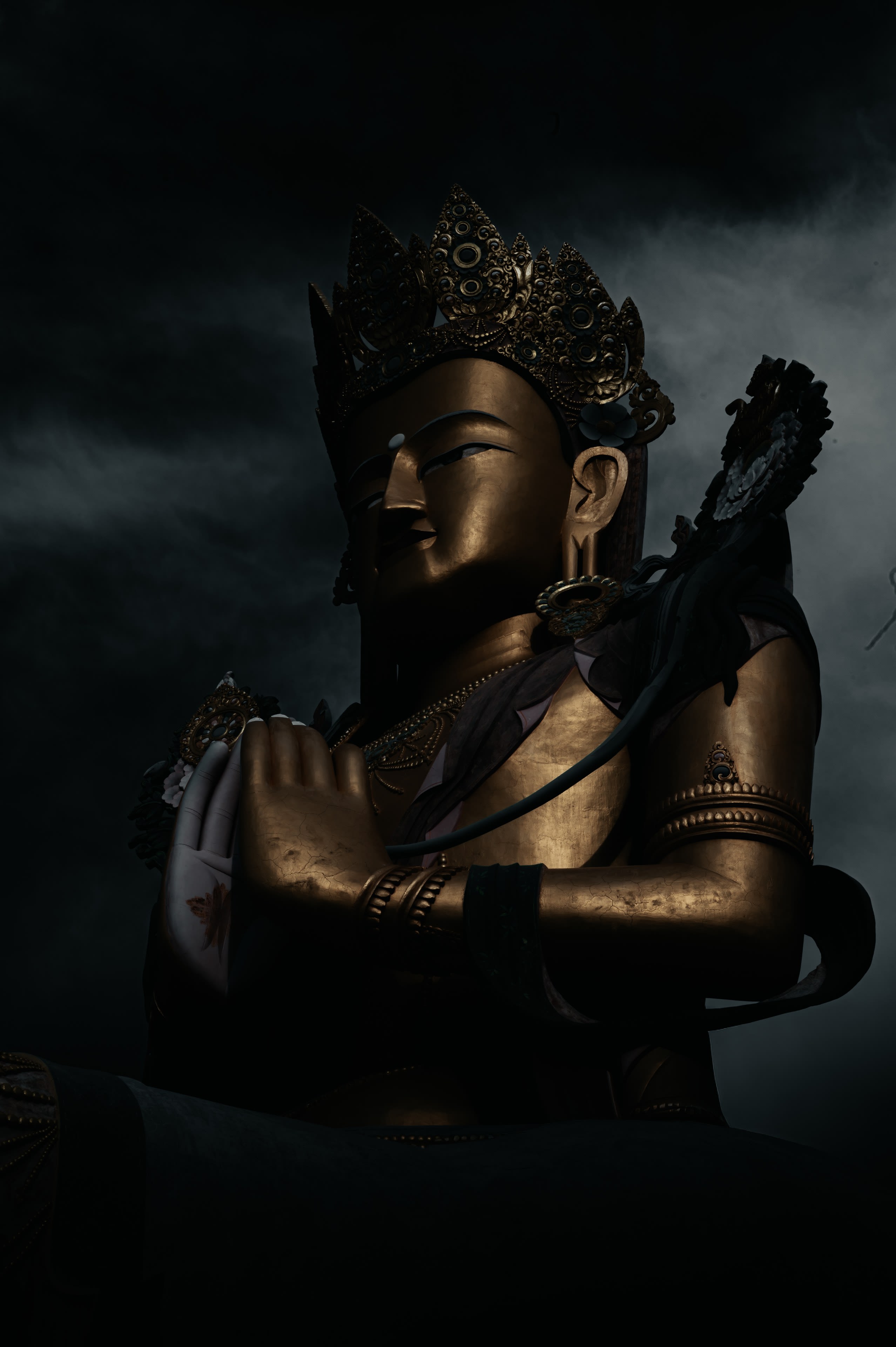 The gilded Maitreya statue of Diskit against dark storm cloud