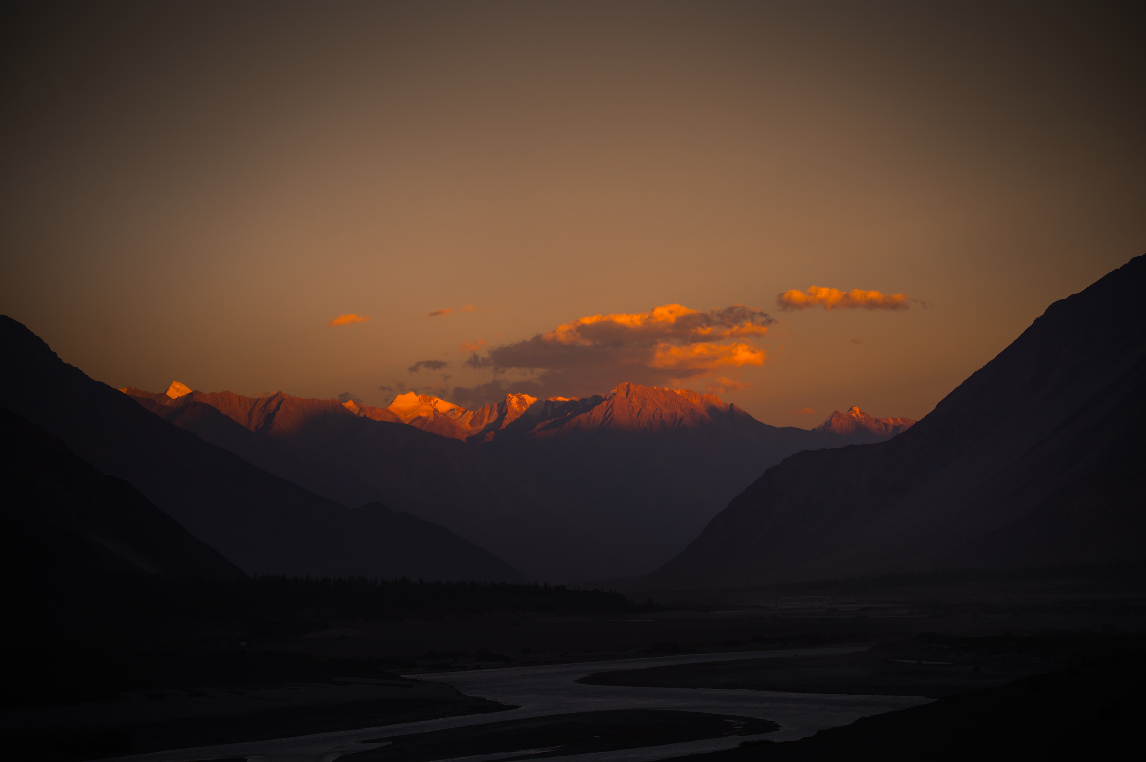 Sunset over silhouetted valley ridgelines