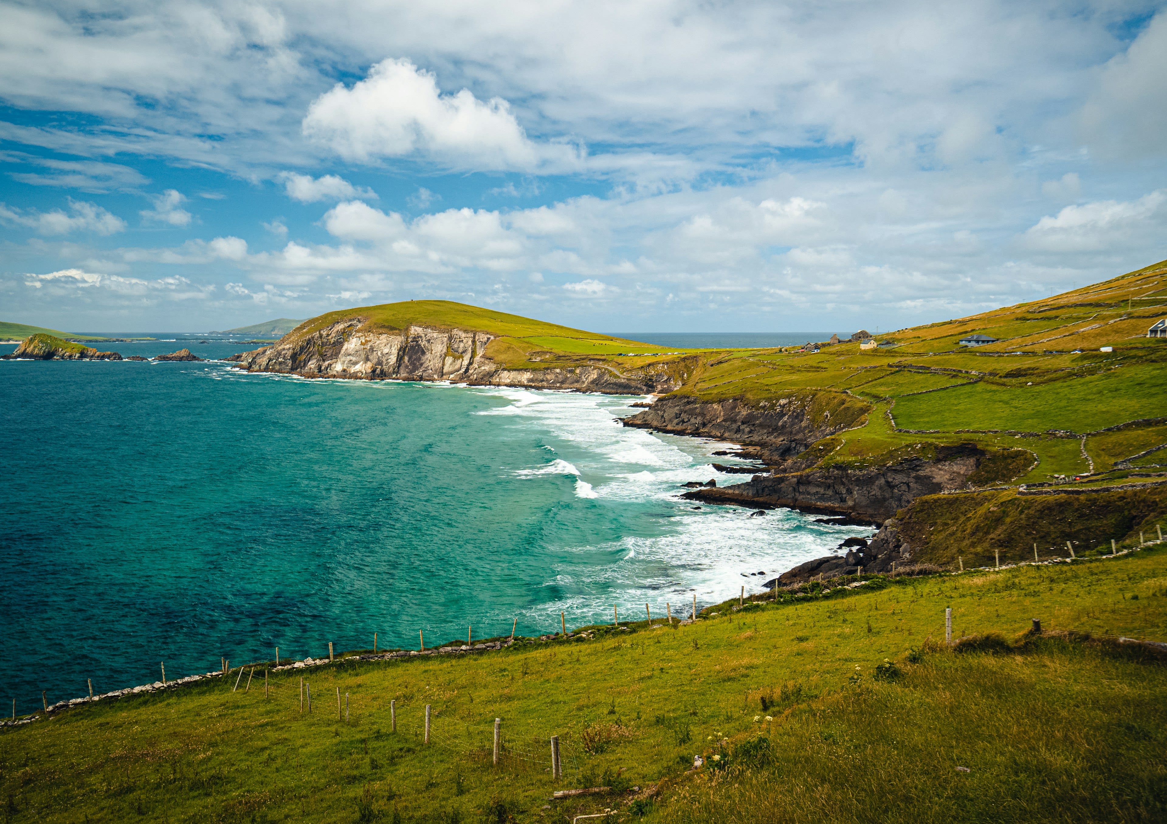 Green headlands stepping down into the Atlantic under moving cloud