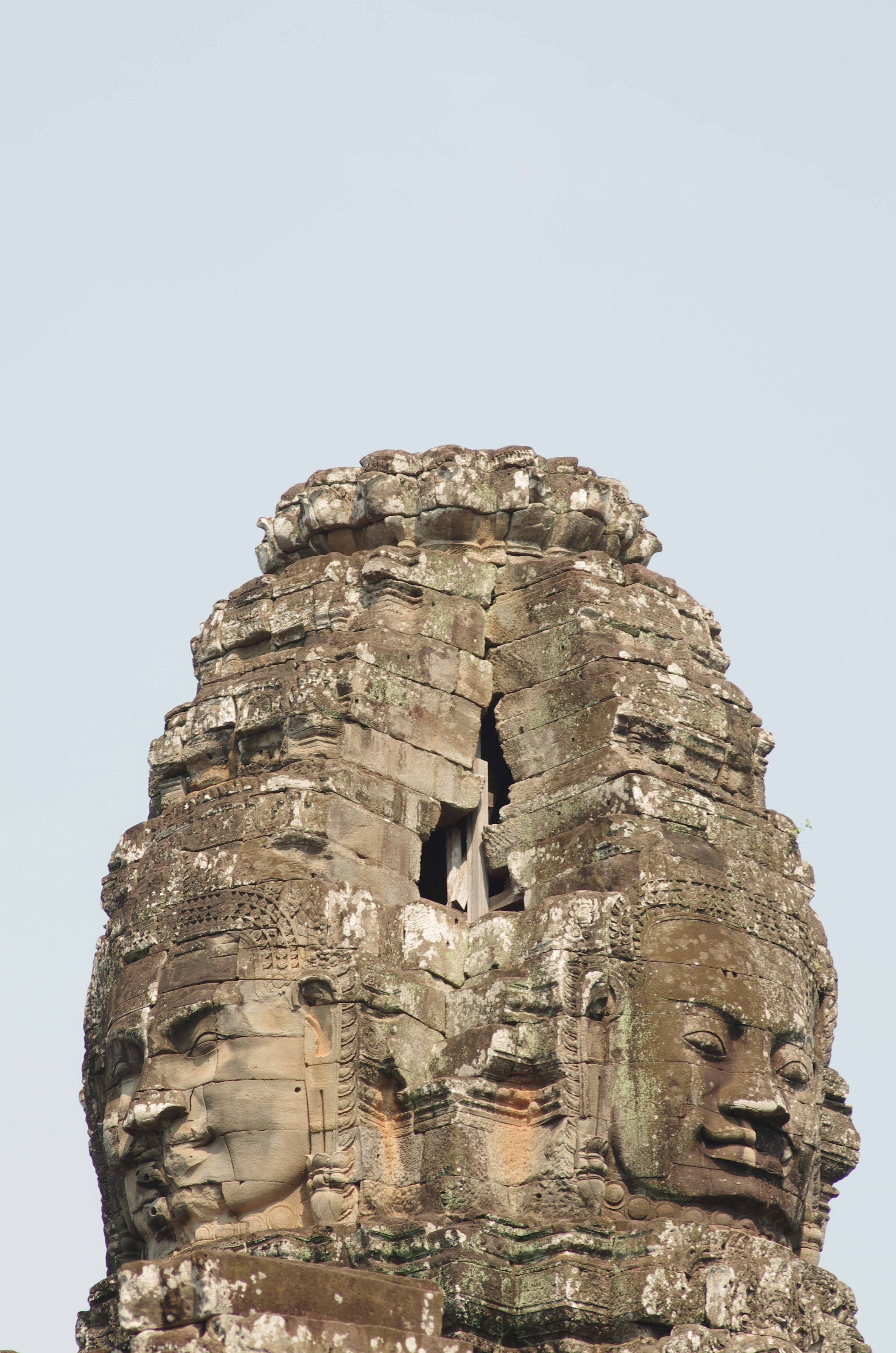 A giant carved stone face on a temple tower