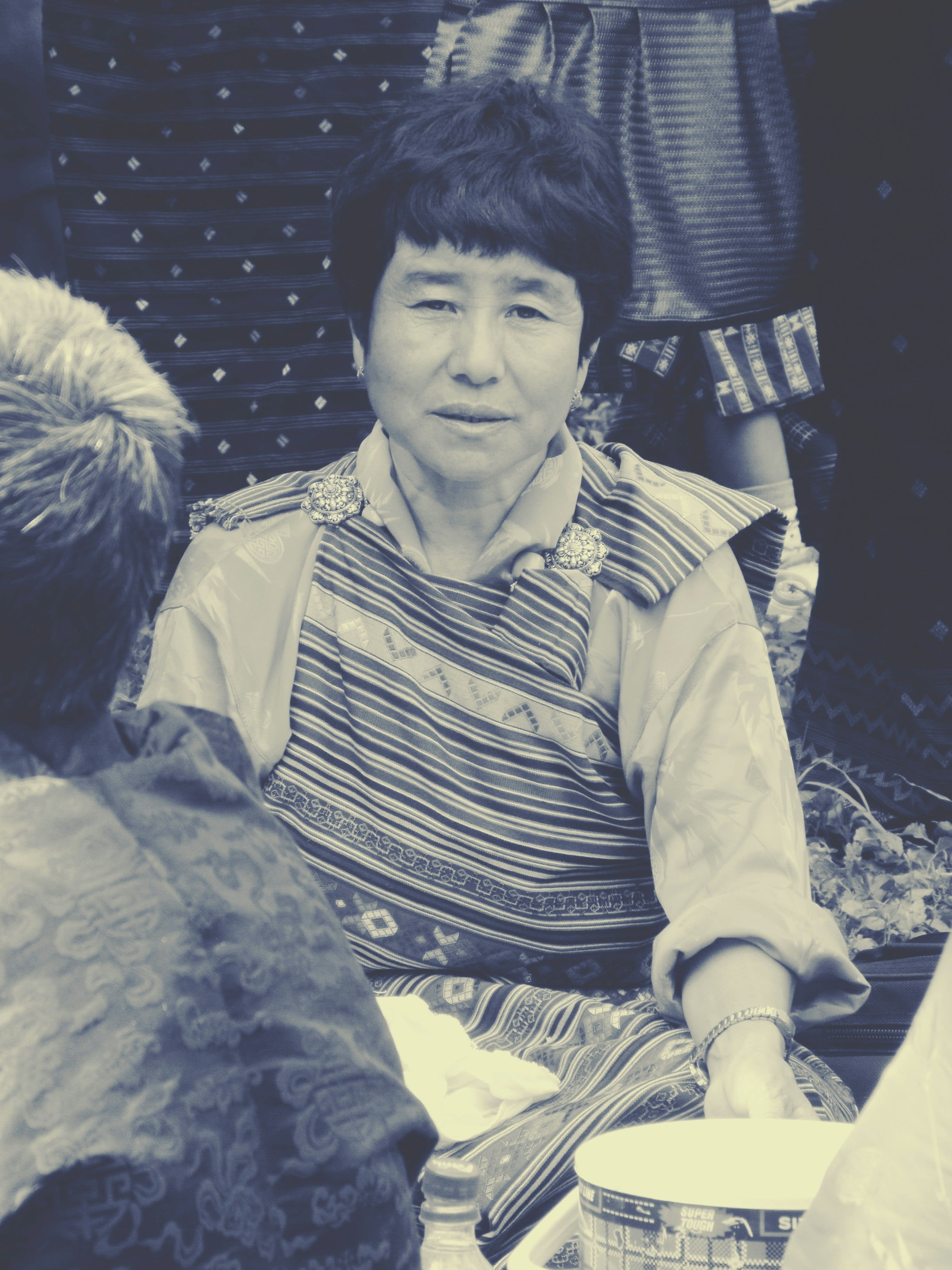 A person seated inside a herder's tent among felt and sheepskin