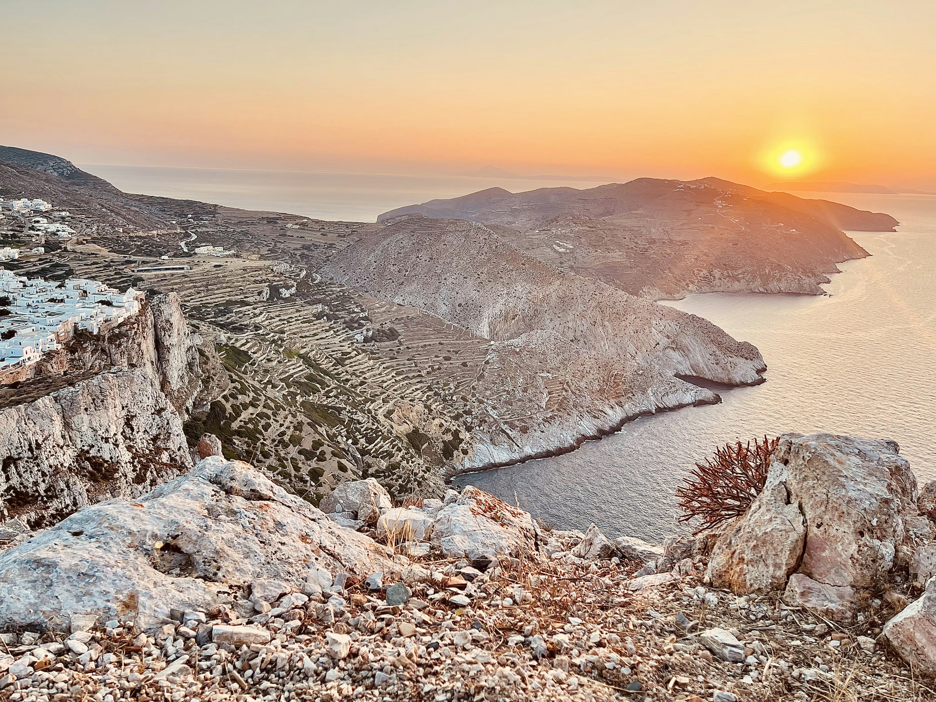 Sunset over cliffs and sea from a high village terrace