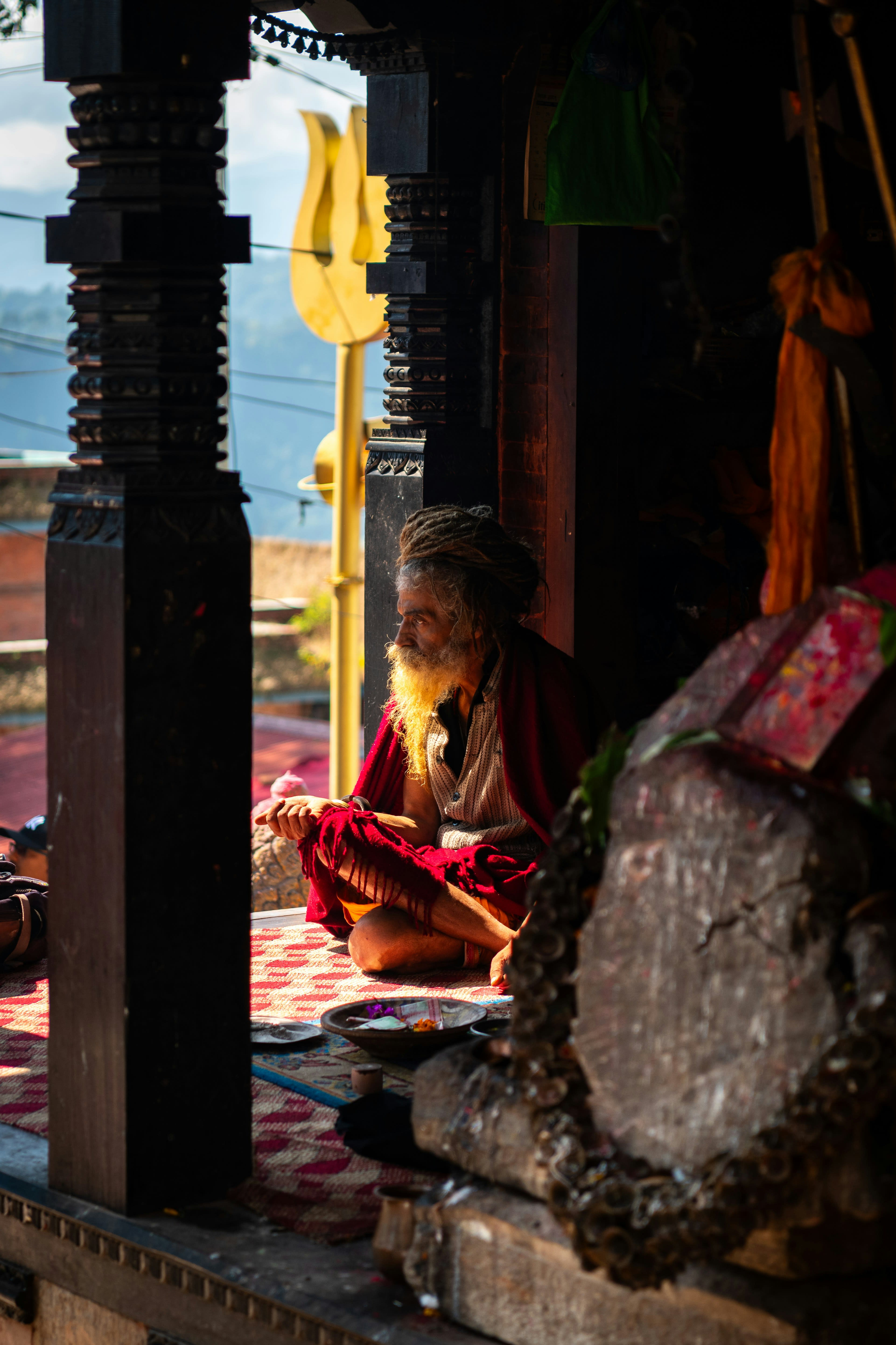 A woman standing in the dark doorway of a village house