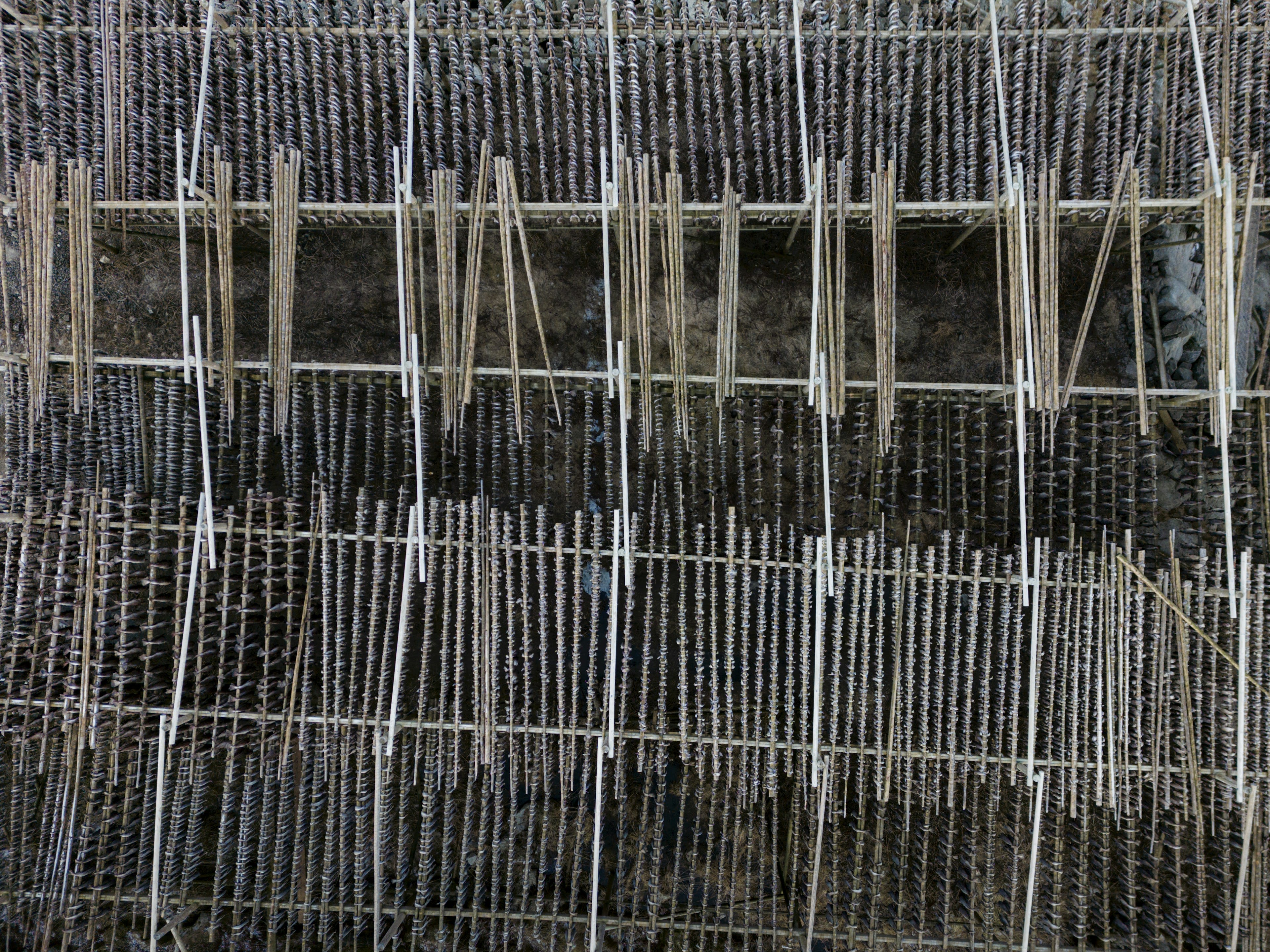 A close view of the crossed poles of a wooden drying rack