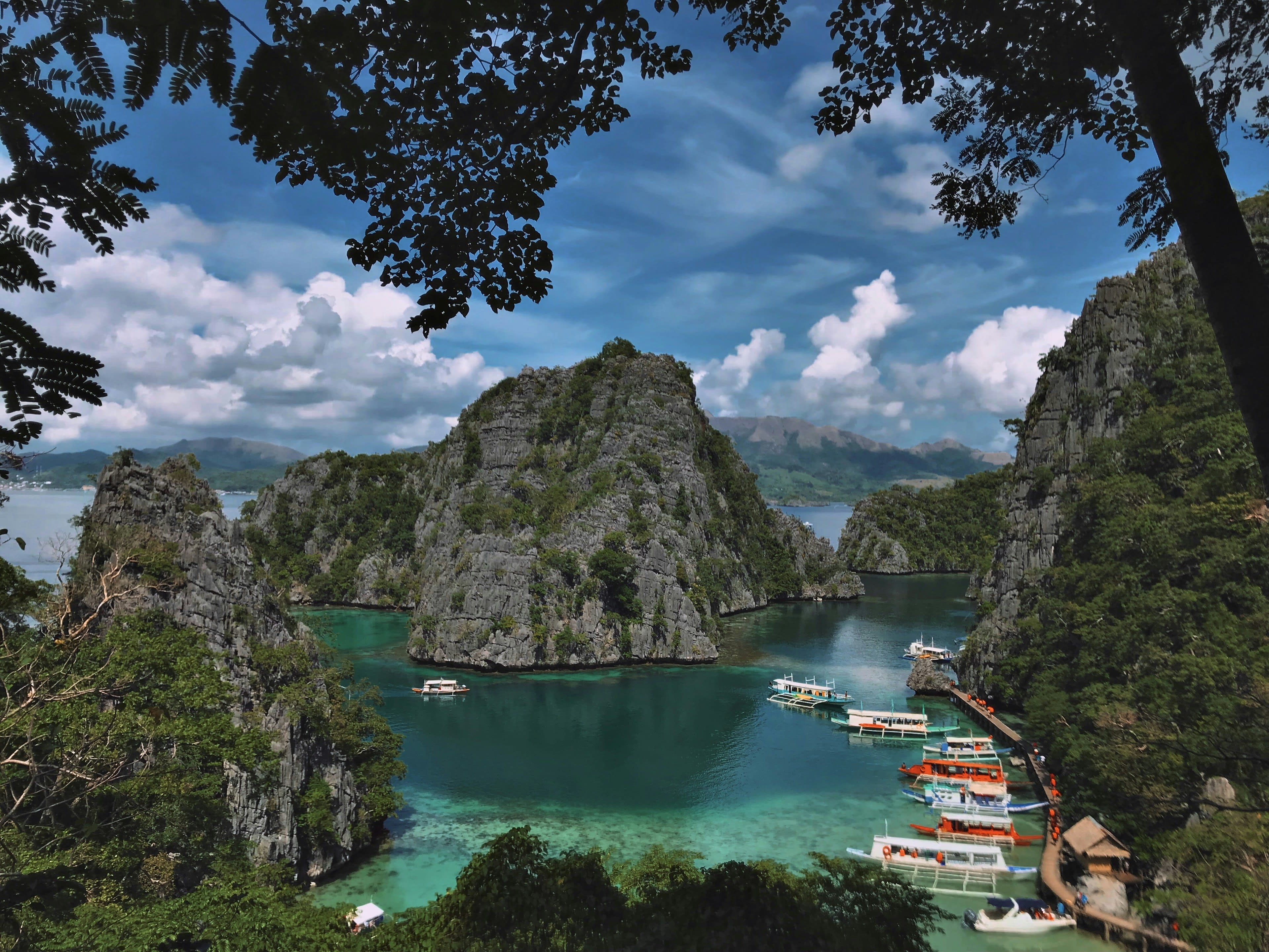 A green-blue lake enclosed by forested limestone hills