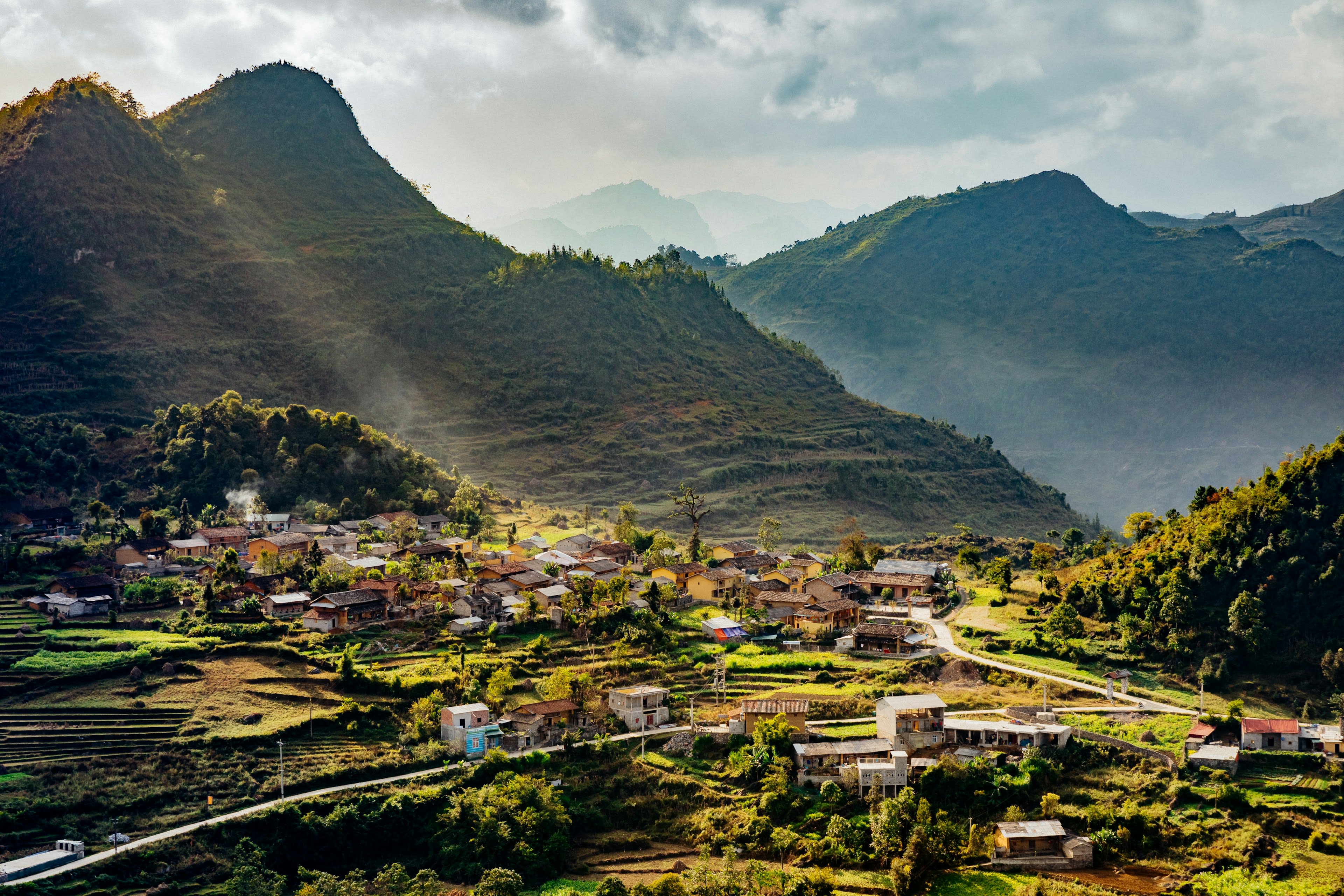 A village and terraced fields in a mountain valley at dusk