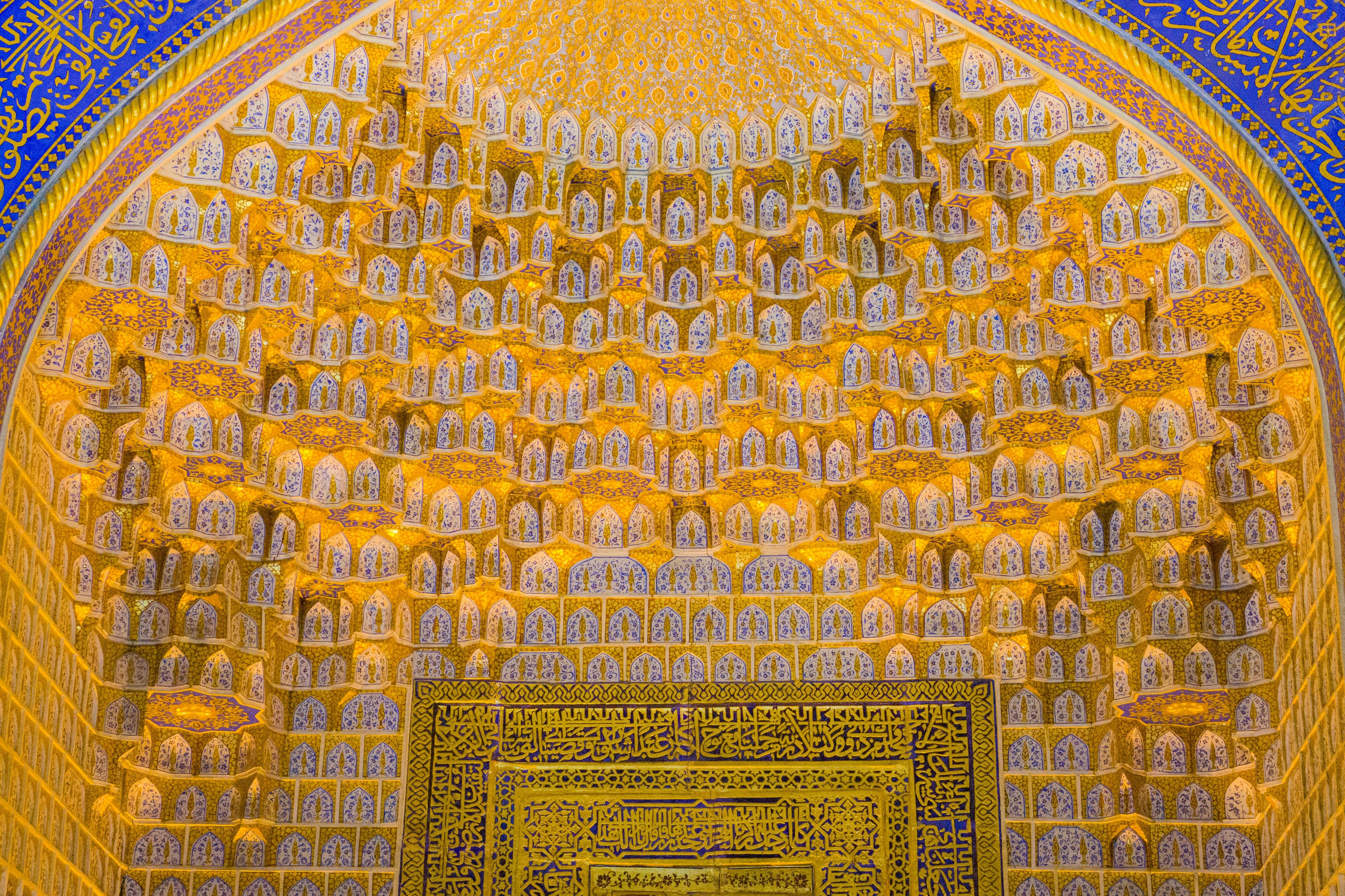 A gilded painted dome interior glowing gold