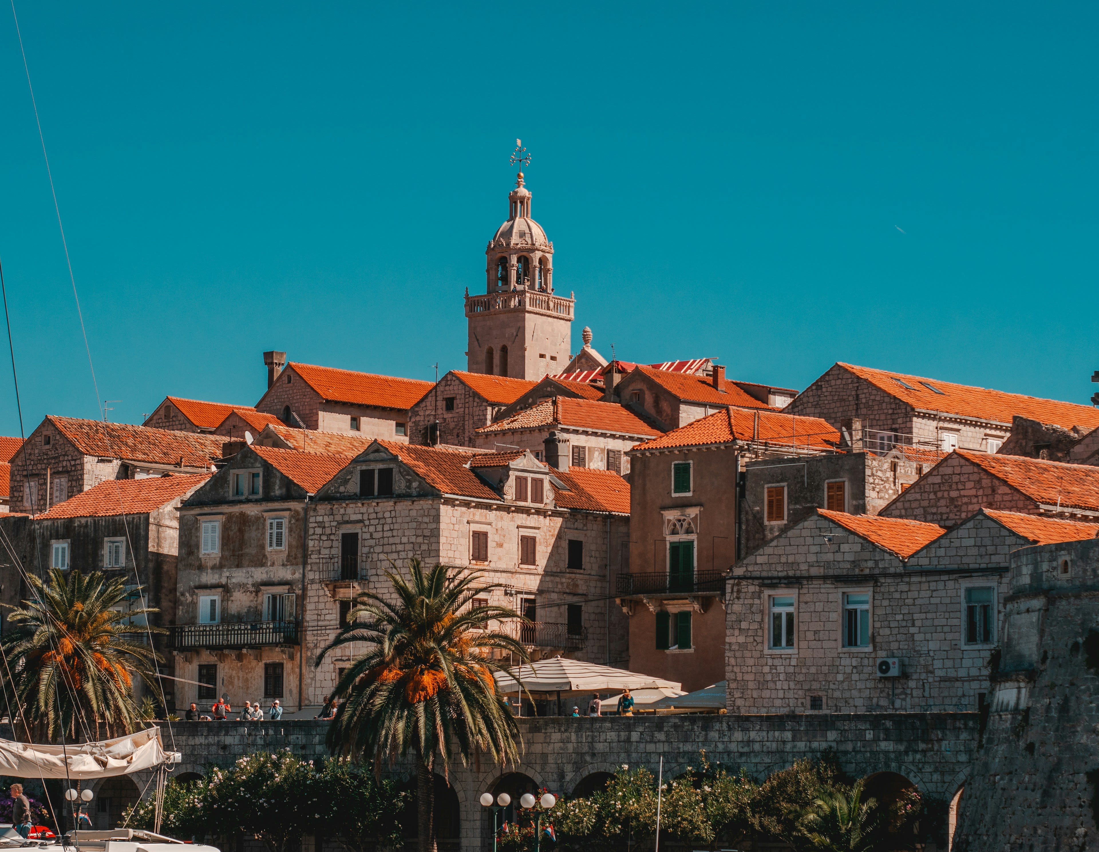 Terracotta rooftops of Korčula old town running down to blue Adriatic water