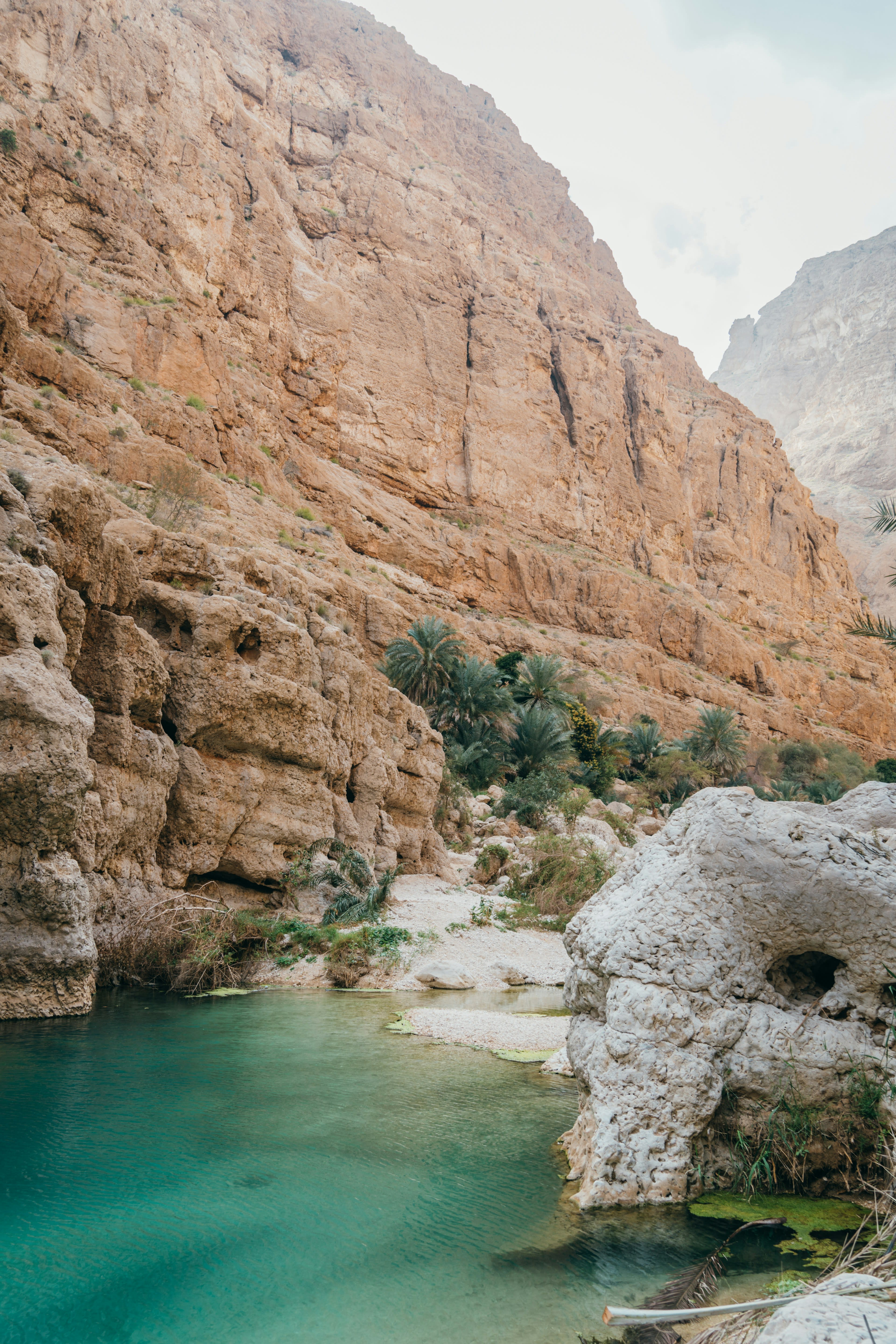 A turquoise pool between sheer rocky canyon walls