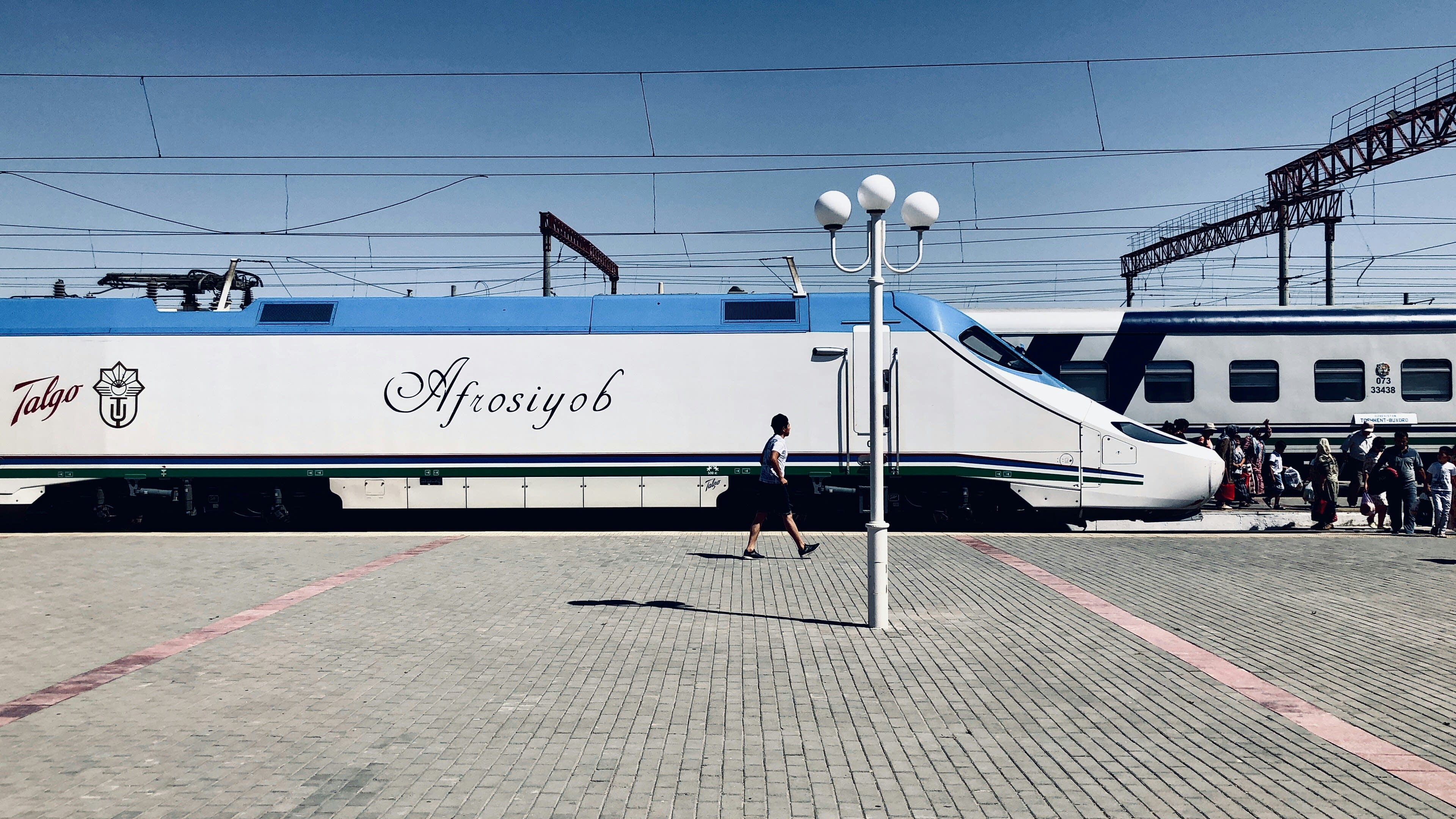 A sleek high-speed train waiting at a station platform