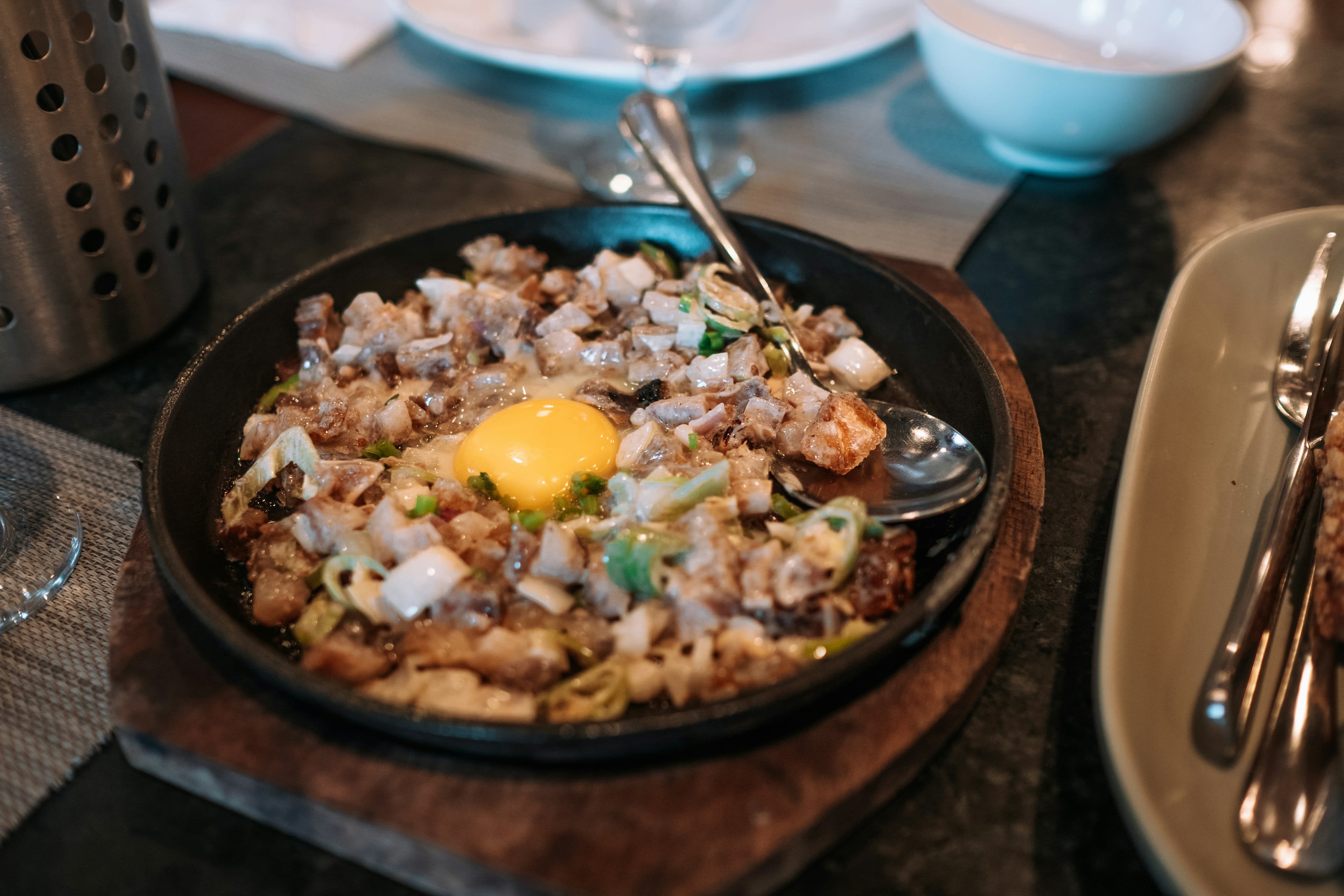A sizzling plate of chopped pork sisig