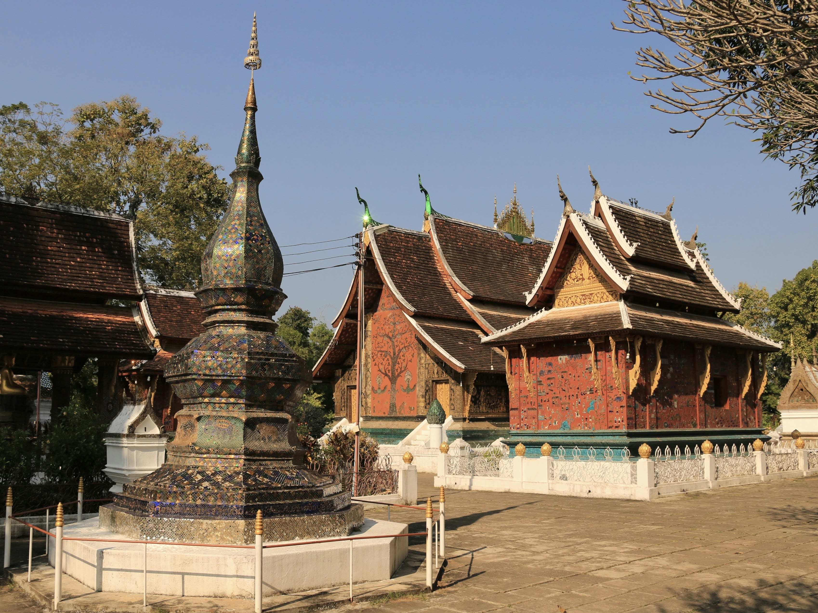 The layered sweeping roofs and gilded facade of a Luang Prabang temple