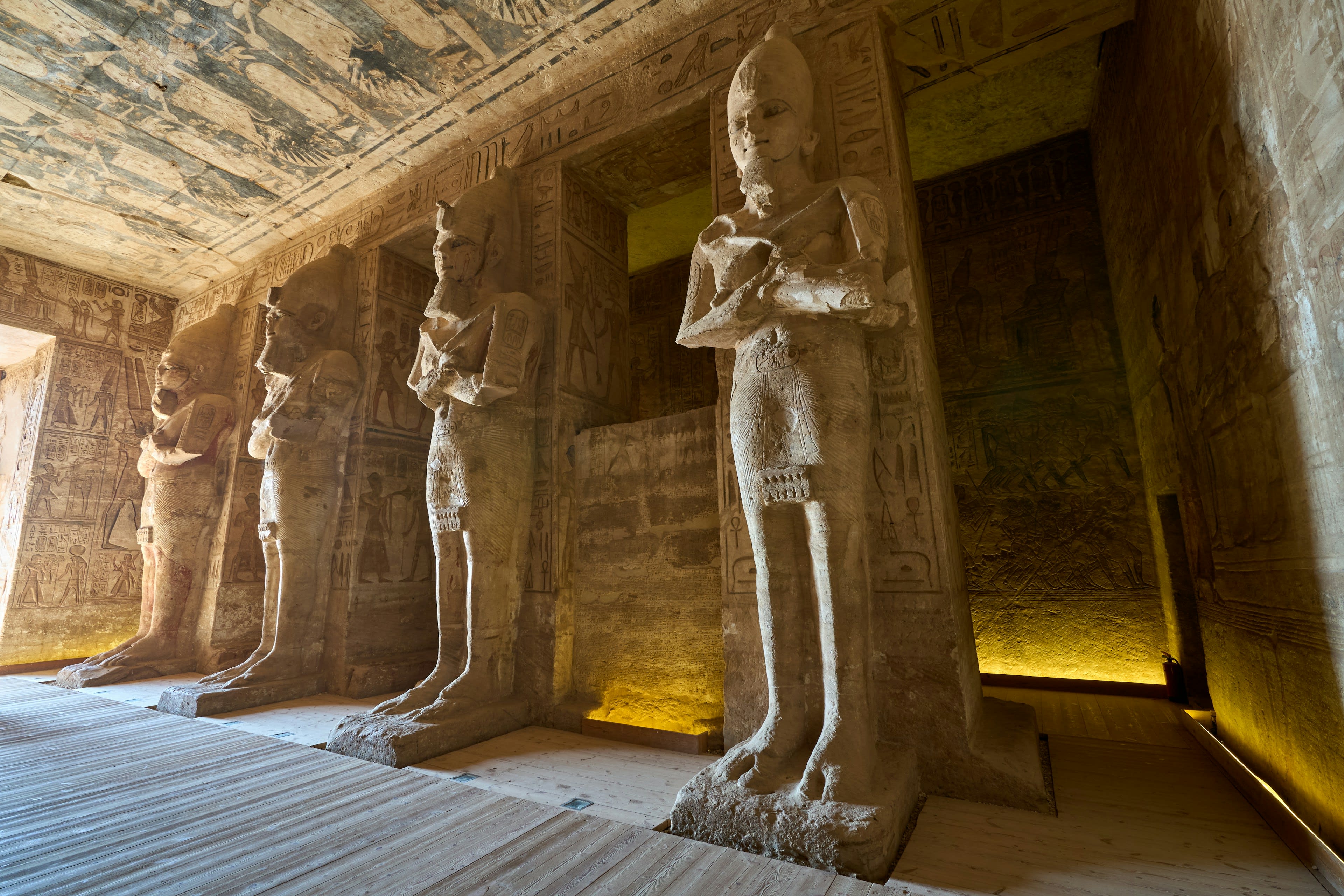 Colossal Osiride statues lining the dim inner hall of Abu Simbel