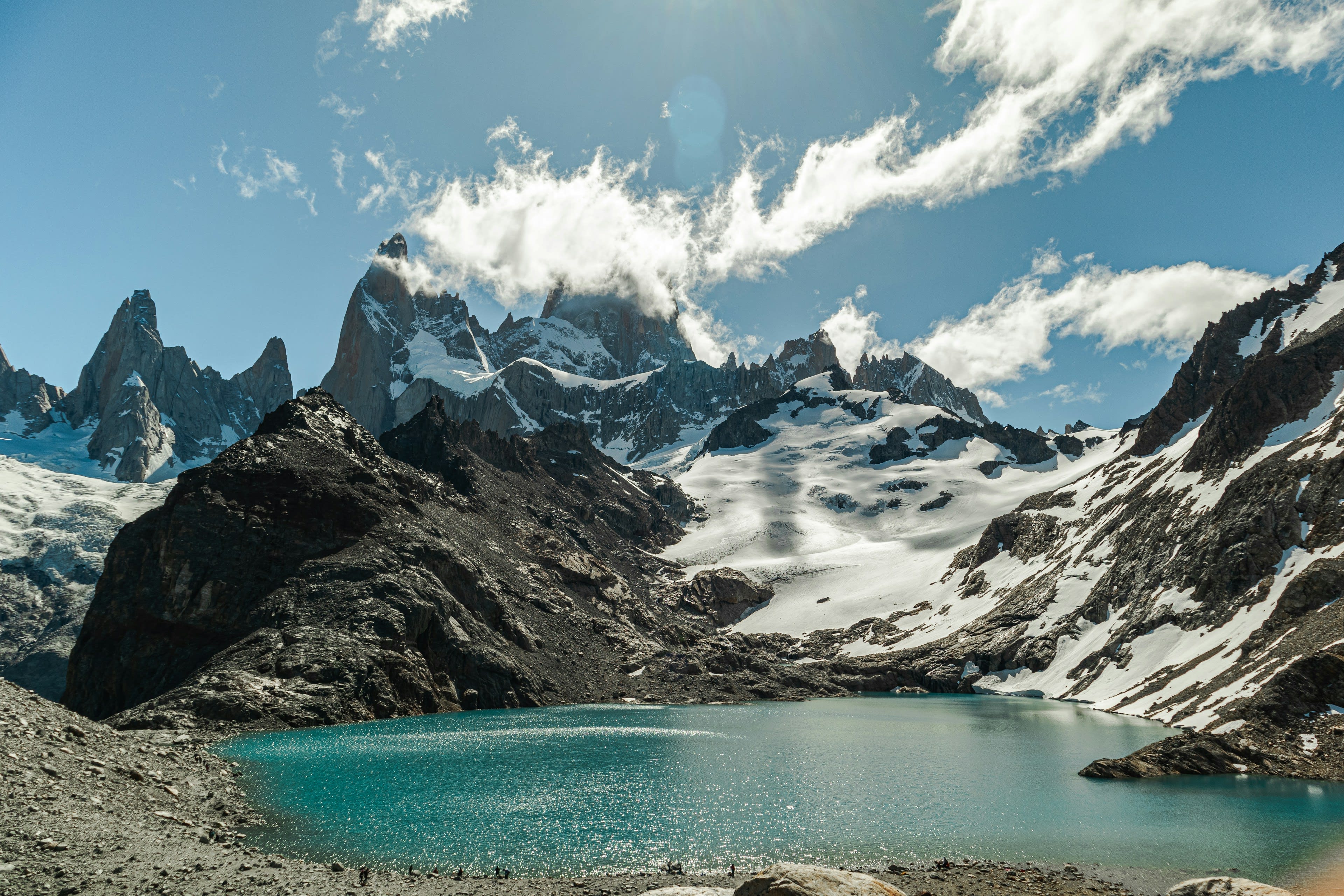 Granite spires above a turquoise glacial lake at first light