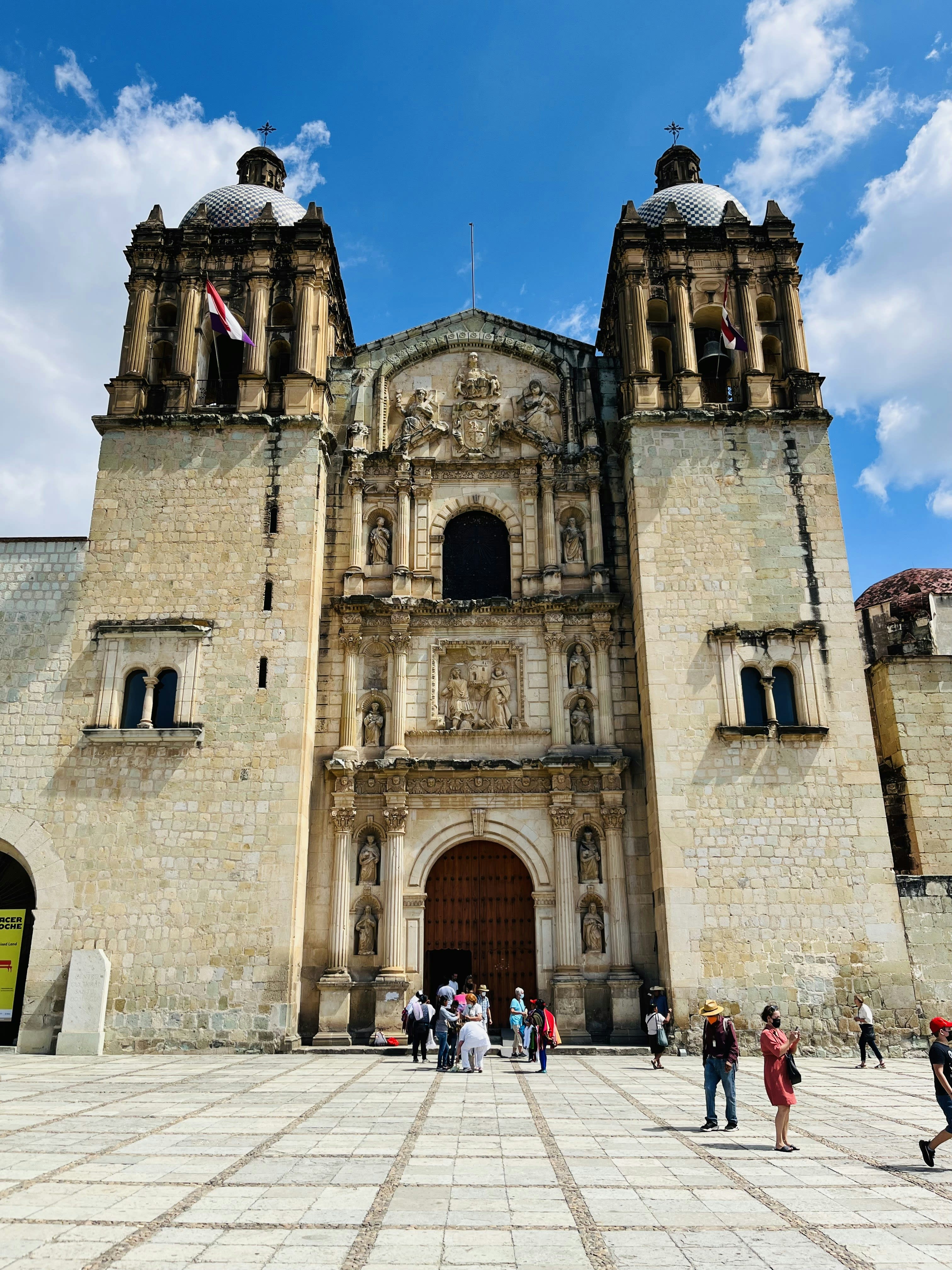 The carved stone facade of Santo Domingo church against a blue sky