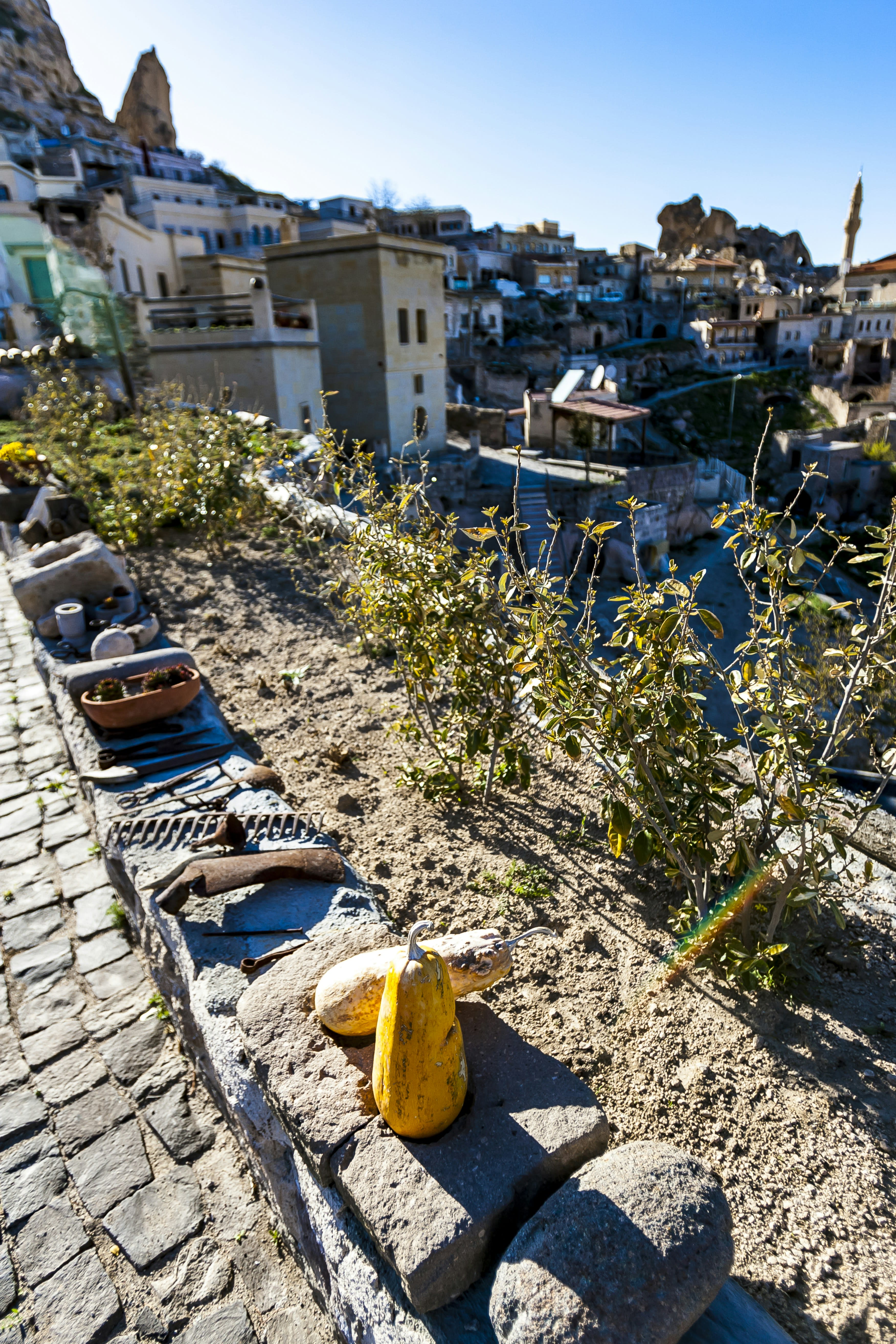 Gourds and pottery arranged on a ledge in warm light