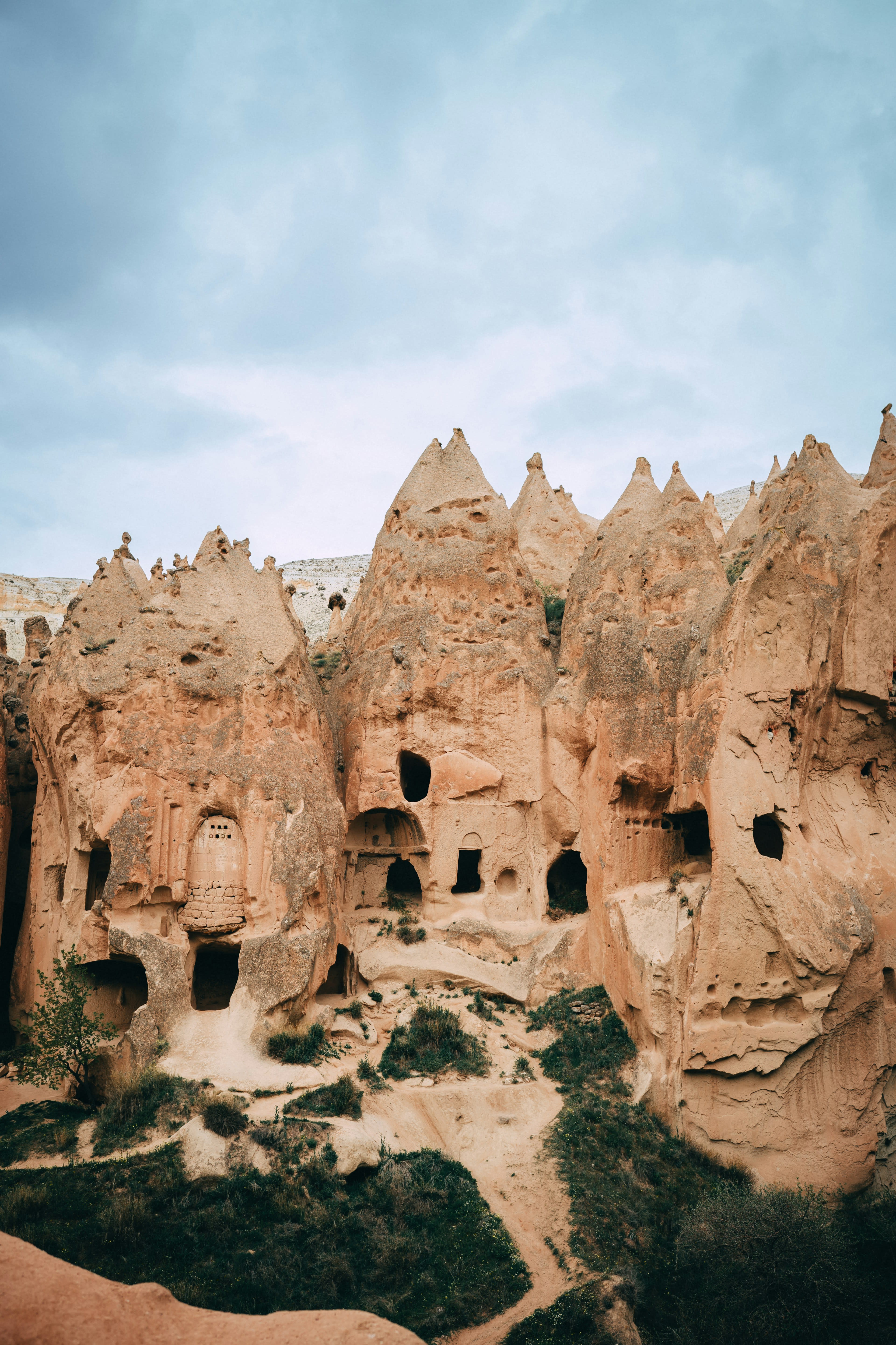 Cave dwellings with carved windows in tall rock cones