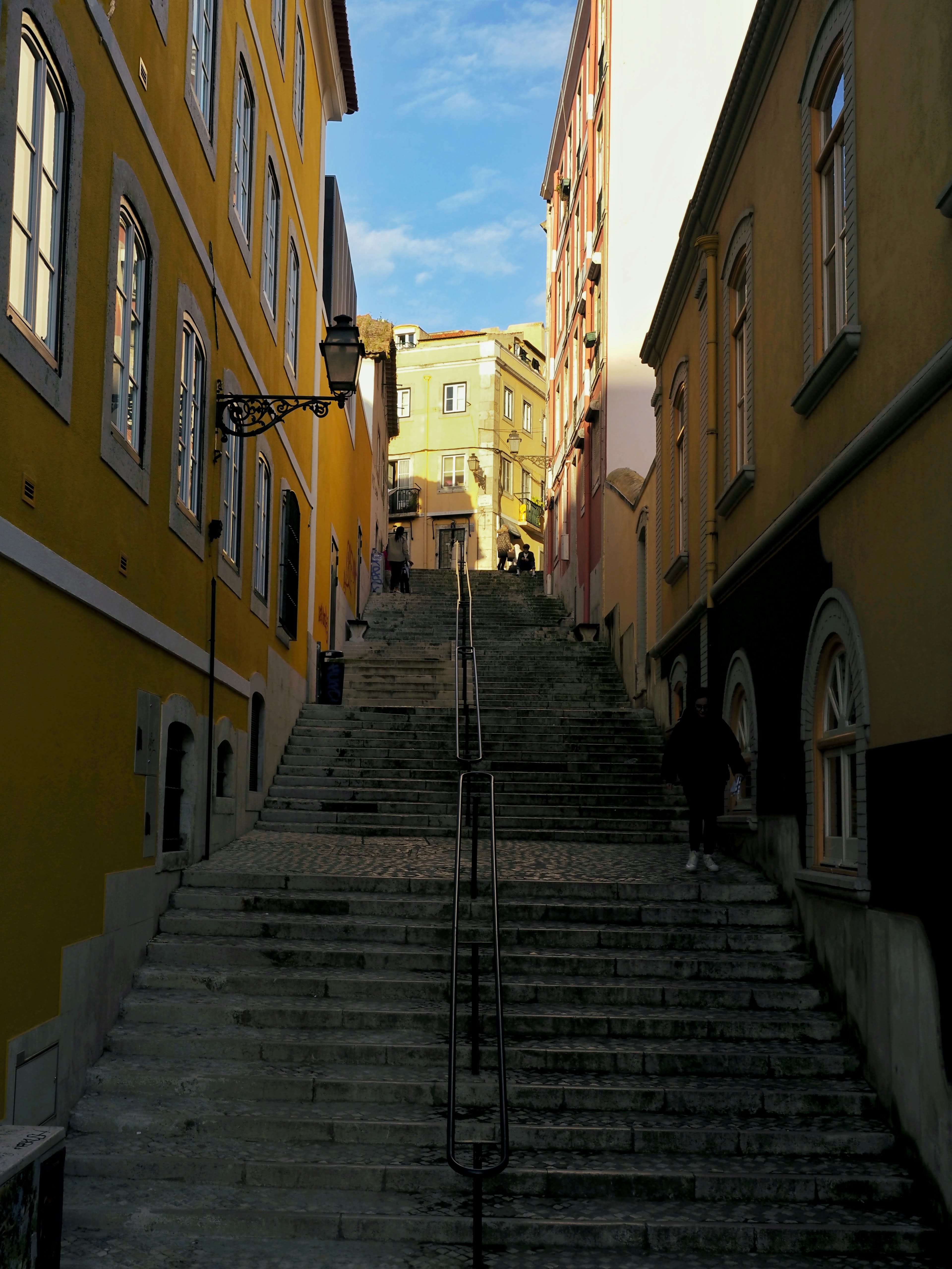 A steep flight of stone steps climbing between pastel buildings