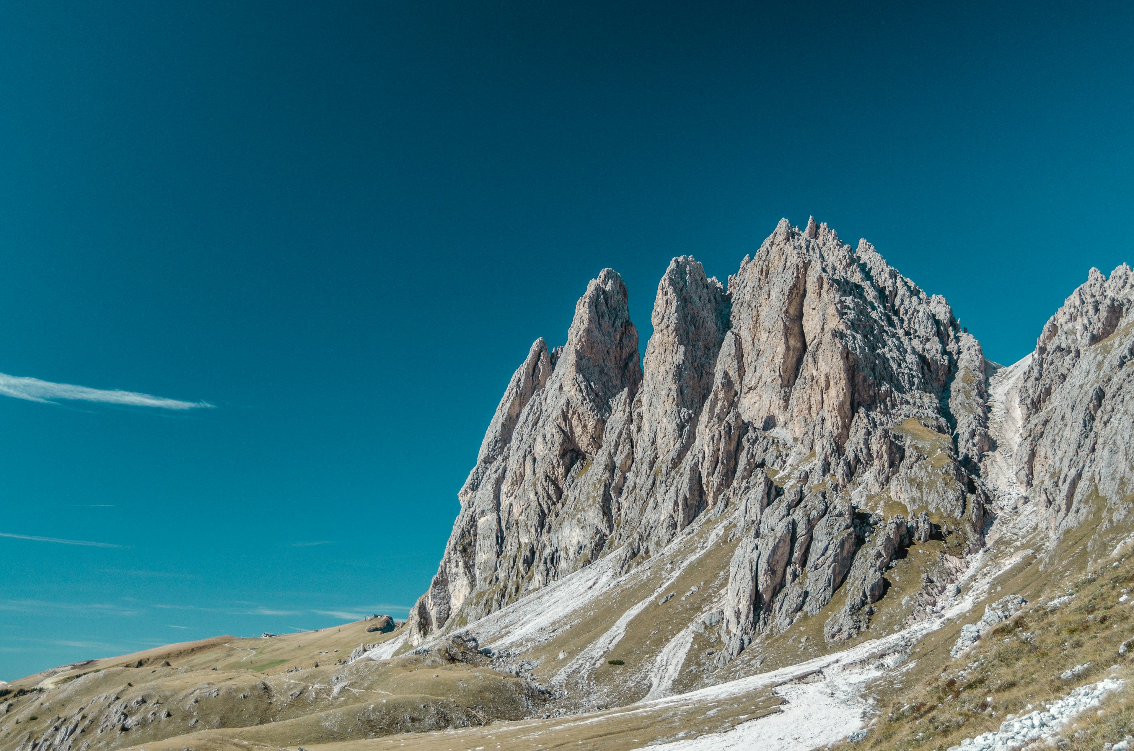 The tilted grass ridgeline of Seceda dropping away to jagged rock teeth