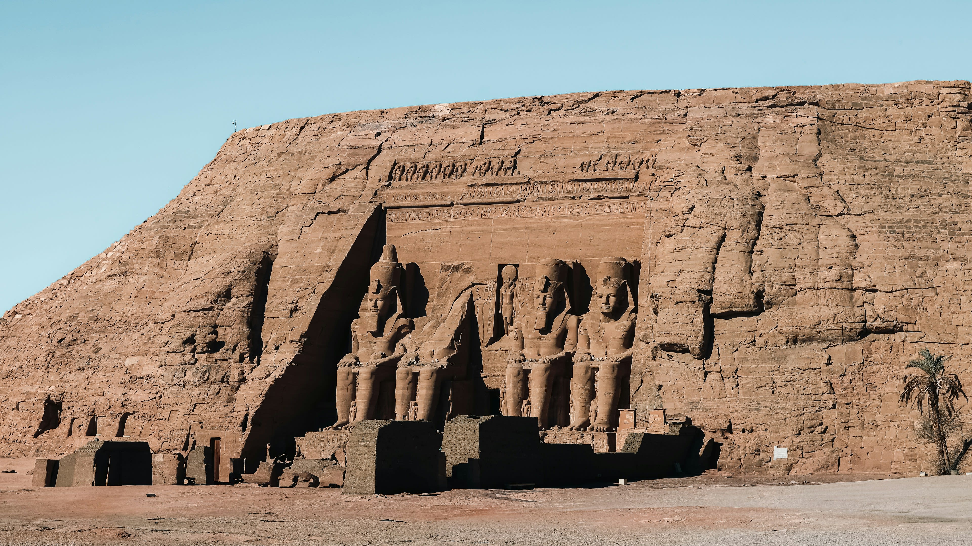 The four colossal seated statues of Ramses II at the Great Temple of Abu Simbel under a dramatic sky