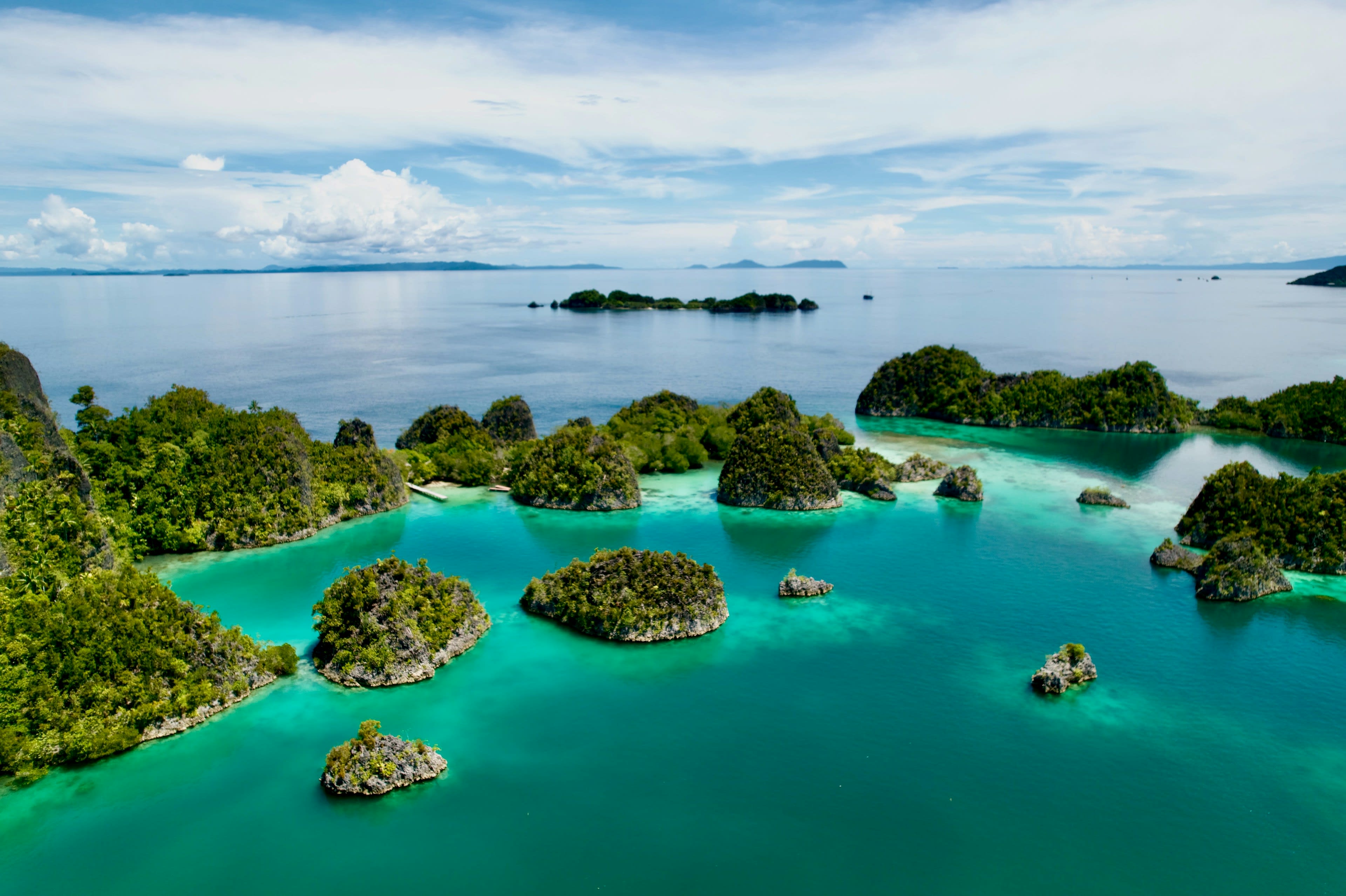 Cone-shaped karst islets scattered across a turquoise lagoon