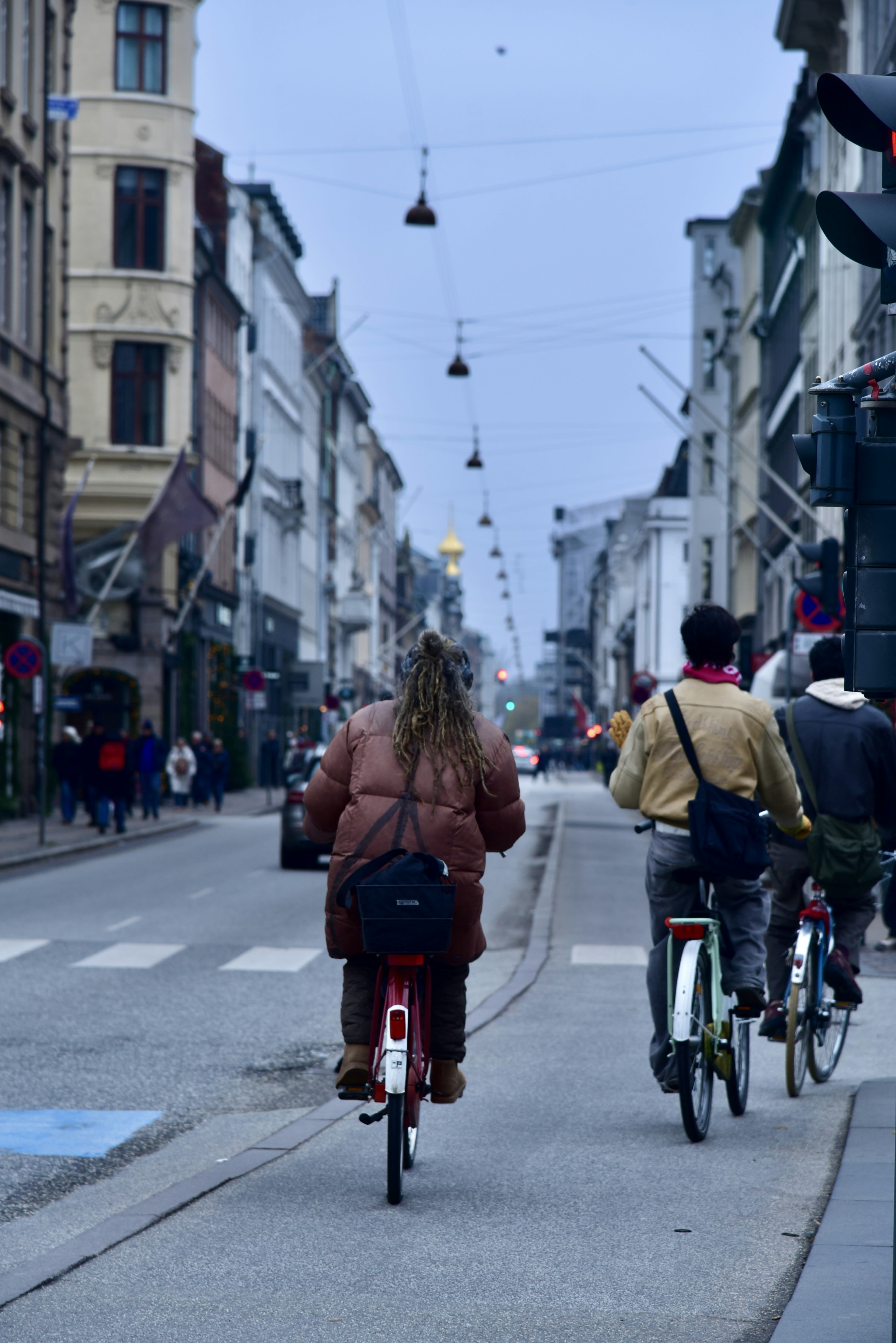 Commuters on bicycles filling a city street in the morning