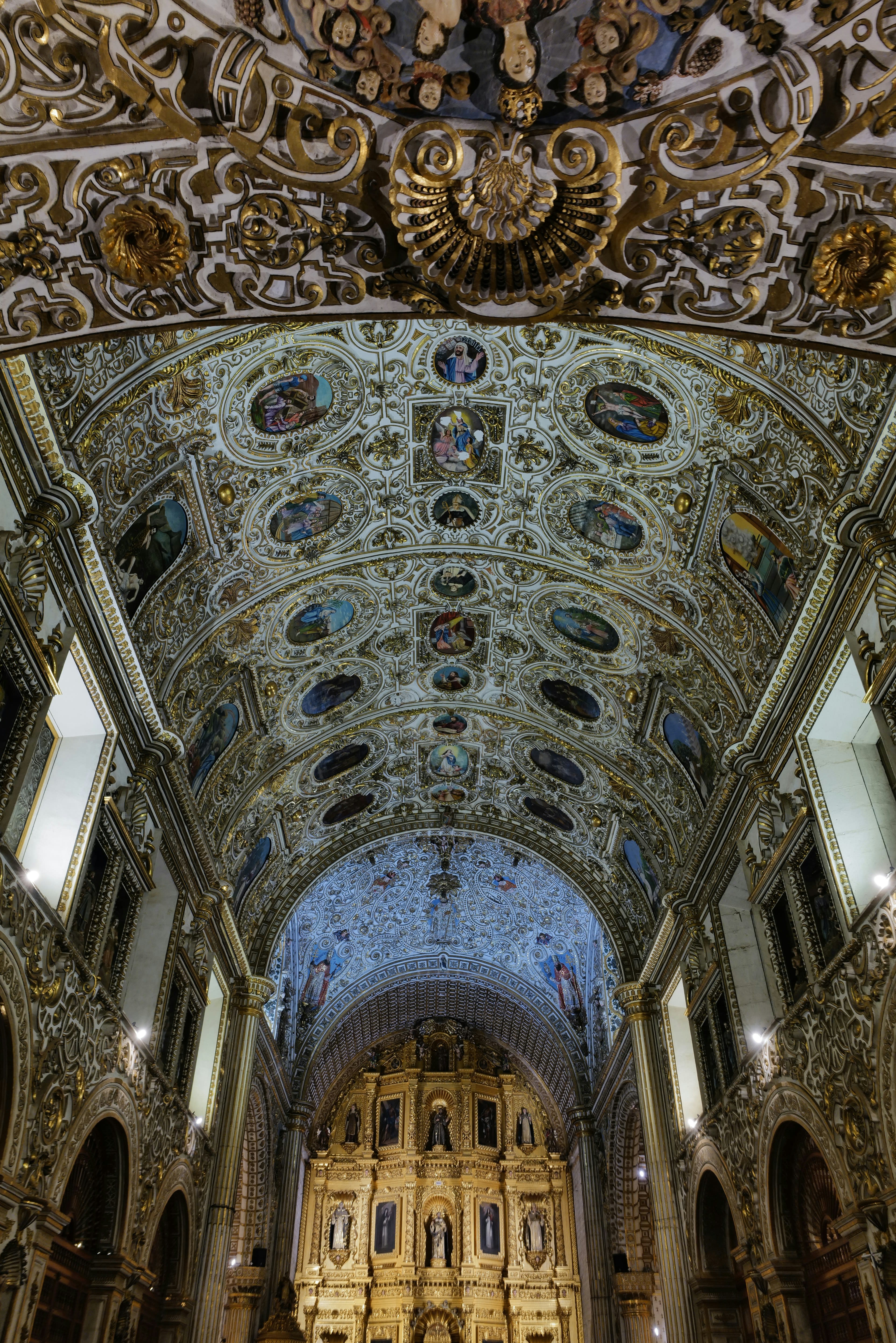 A gilded baroque church ceiling dense with ornament