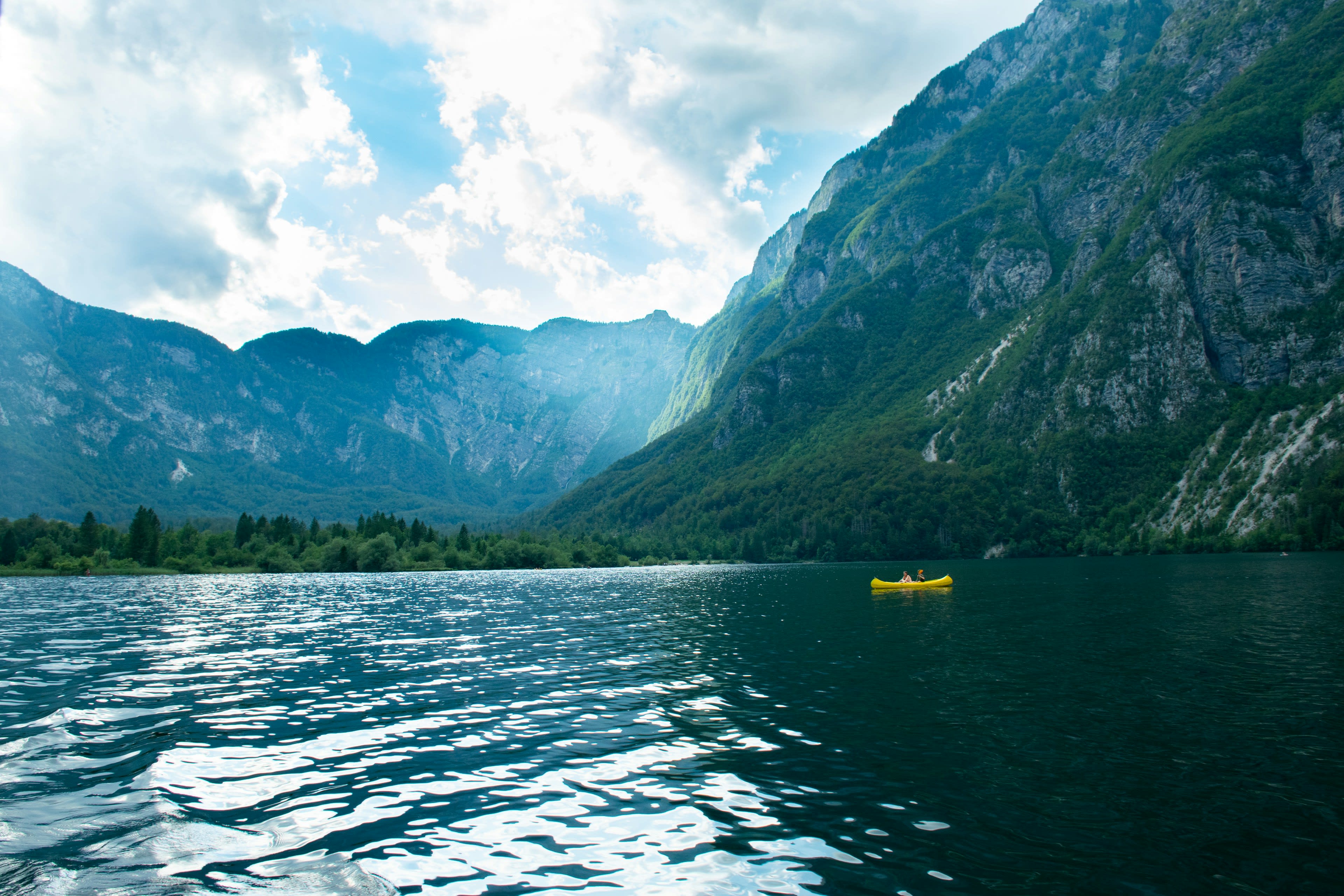 Green mountains rising over a calm blue alpine lake