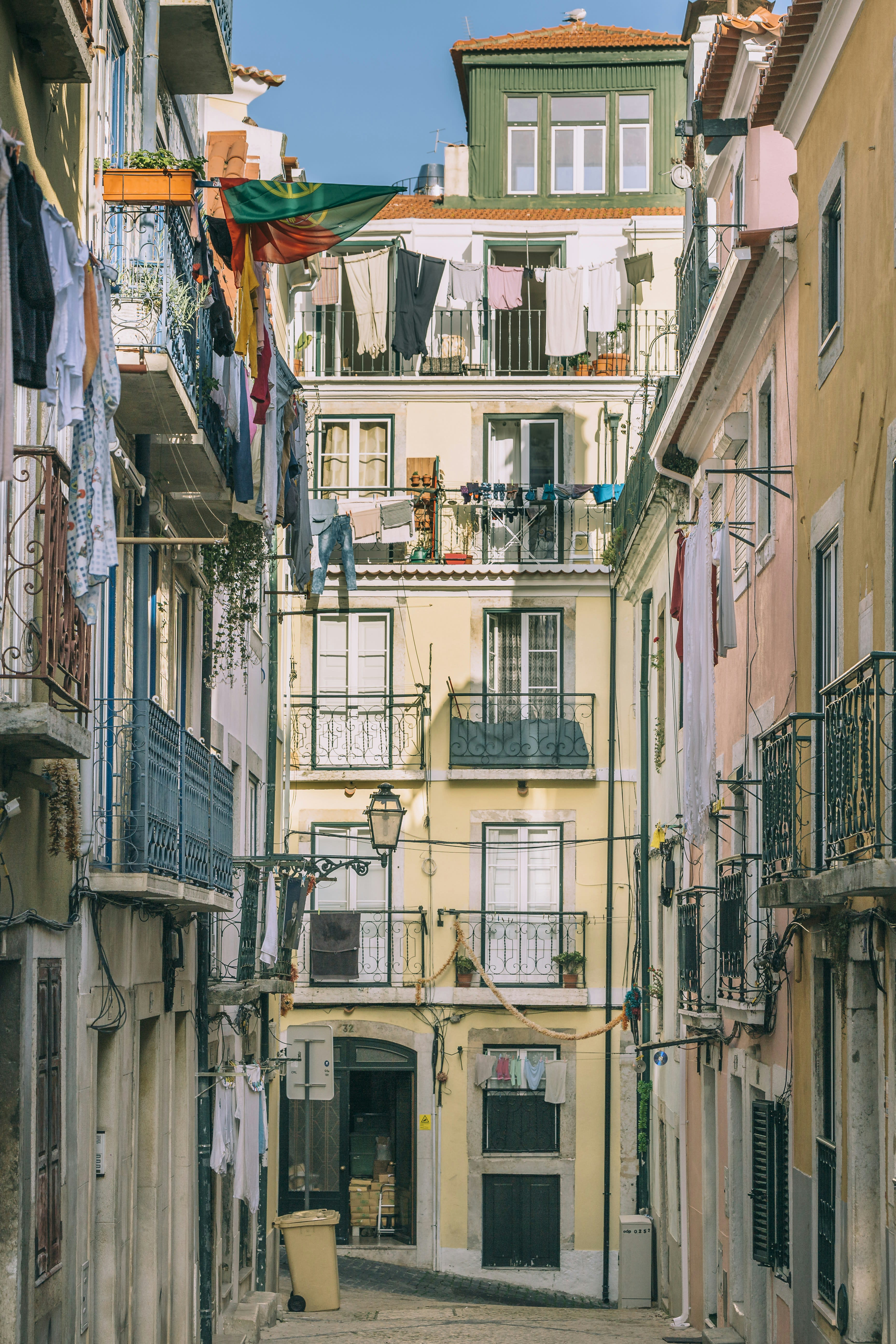 Laundry hanging on lines between the balconies of tall narrow painted houses
