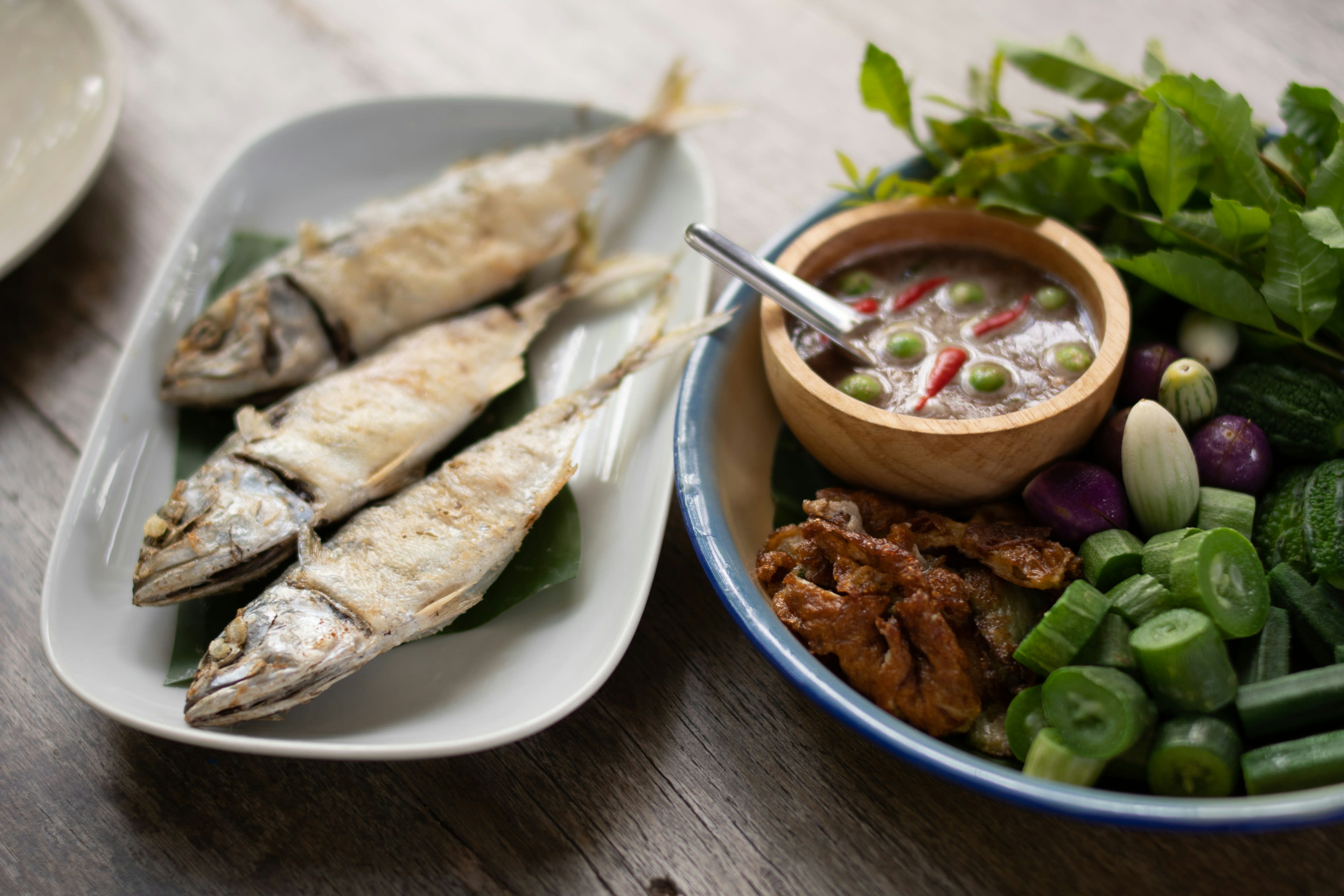 A creamy fish curry served in a dish on a white plate