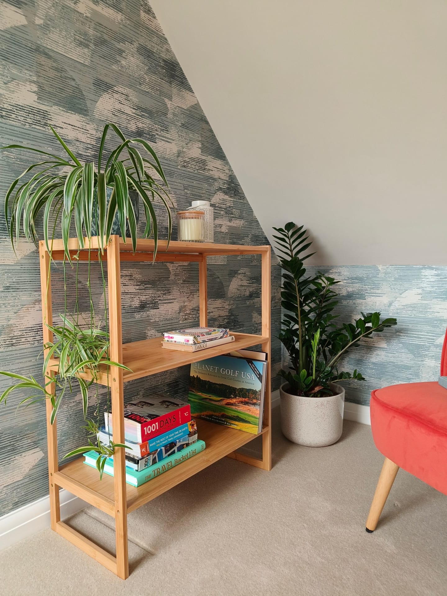 Cosy reading nook with textured wallpaper and plants