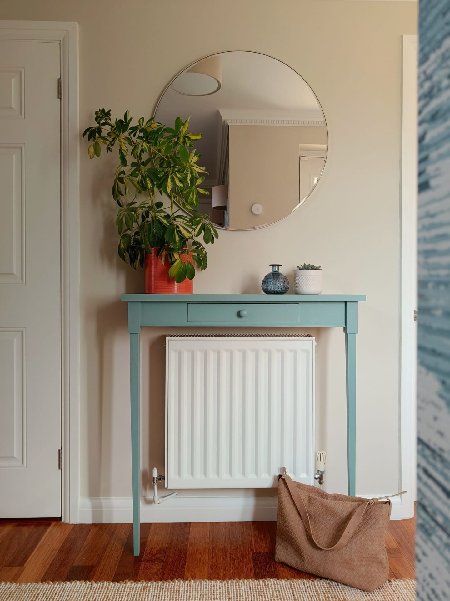 Blue radiator console in calming neutral hallway
