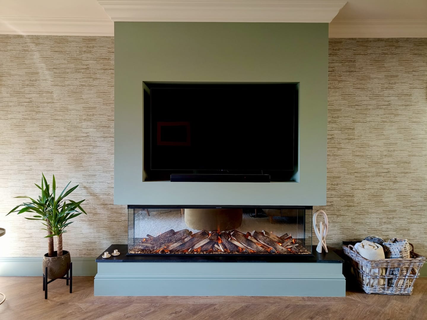 Media unit with fire under and textured wallpaper either side