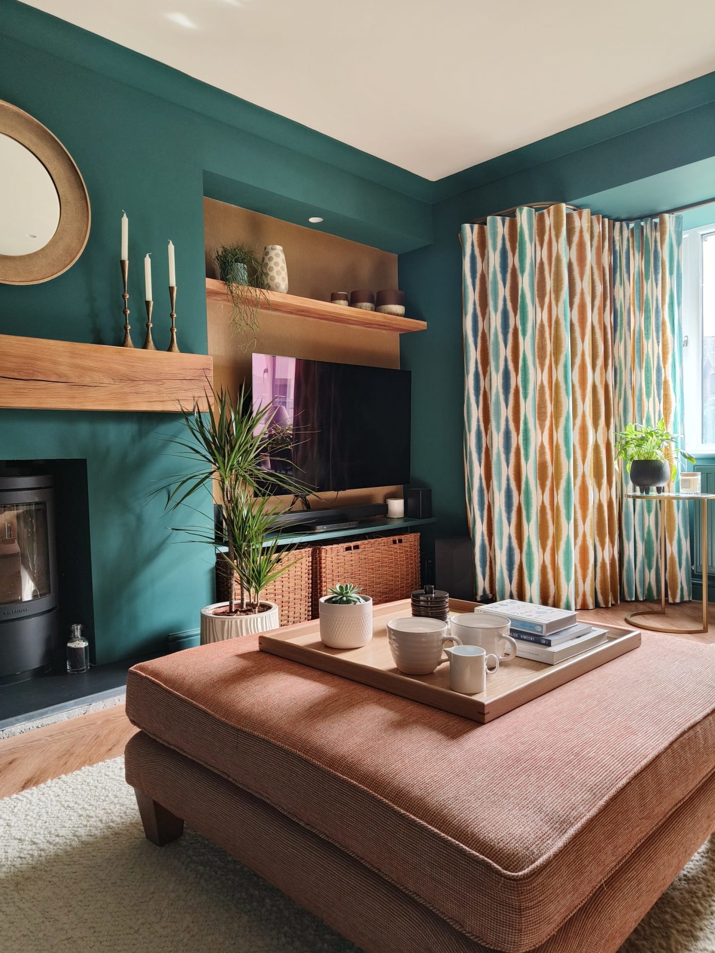 Teal living room with terracotta footstool and oak mantel