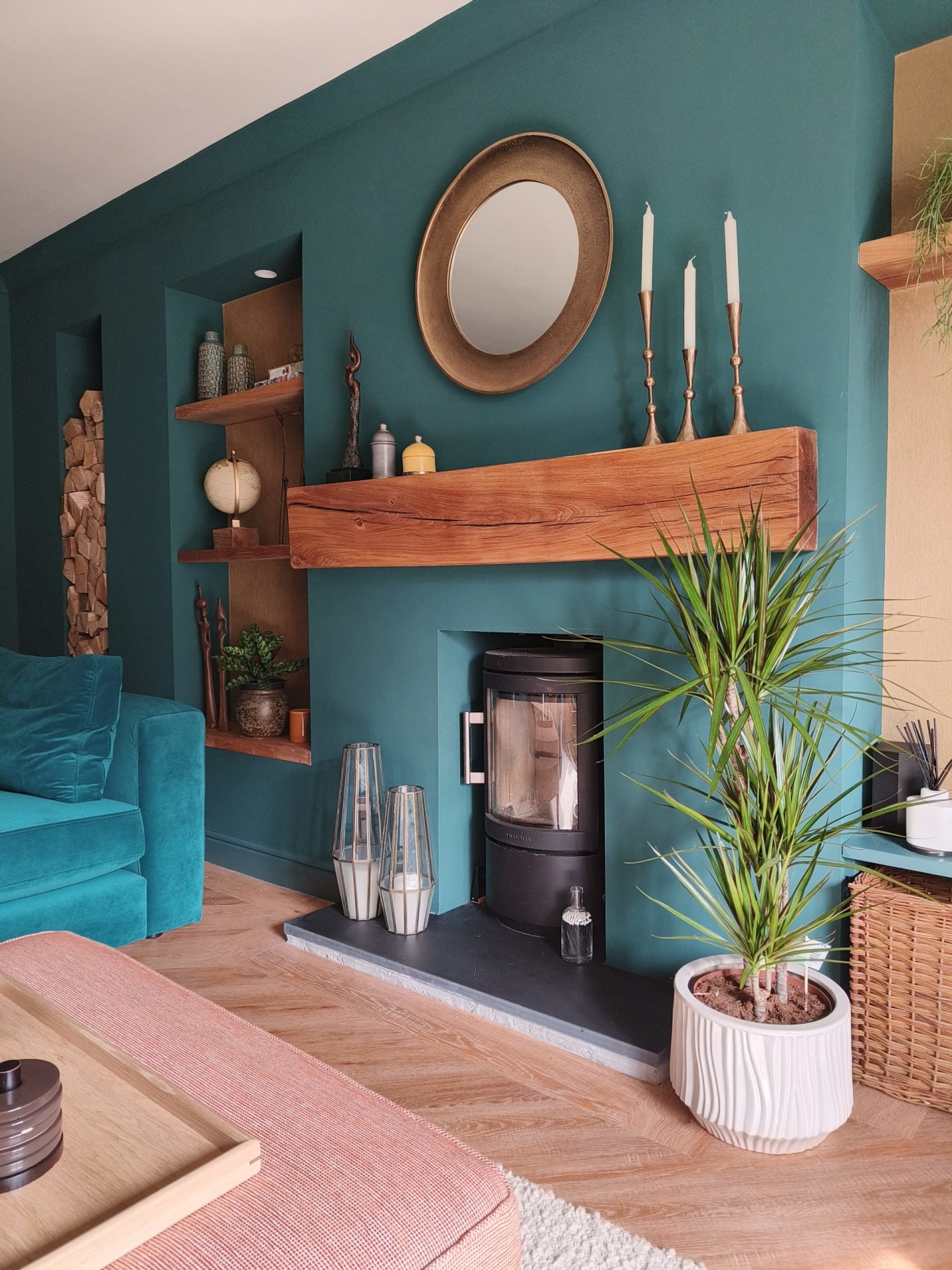 Oak mantel in teal living room