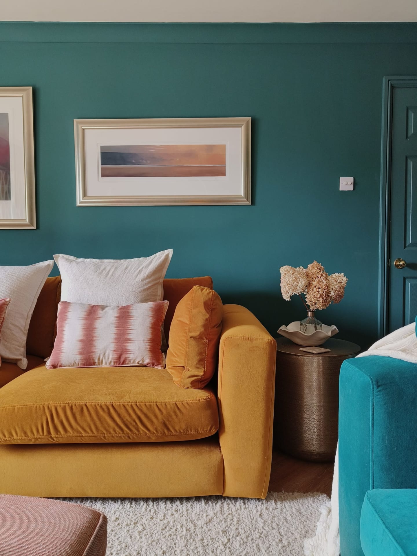 Mustard sofa in teal living room