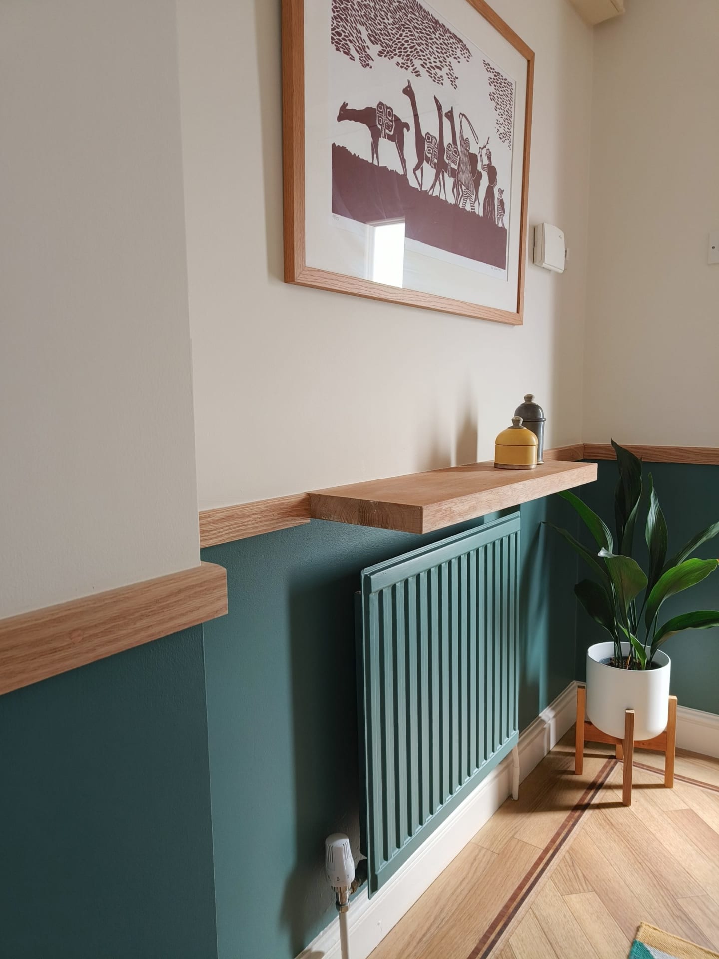 Teal & oak hallway with painted radiator