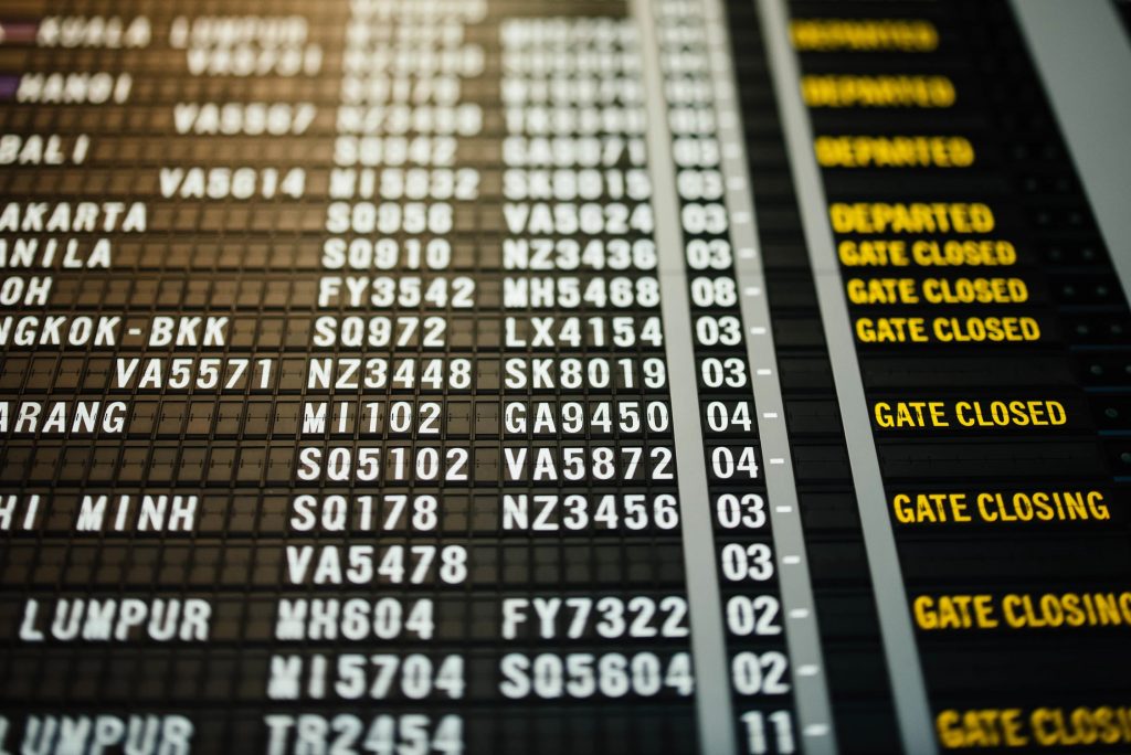 an ariport information board showing flight information