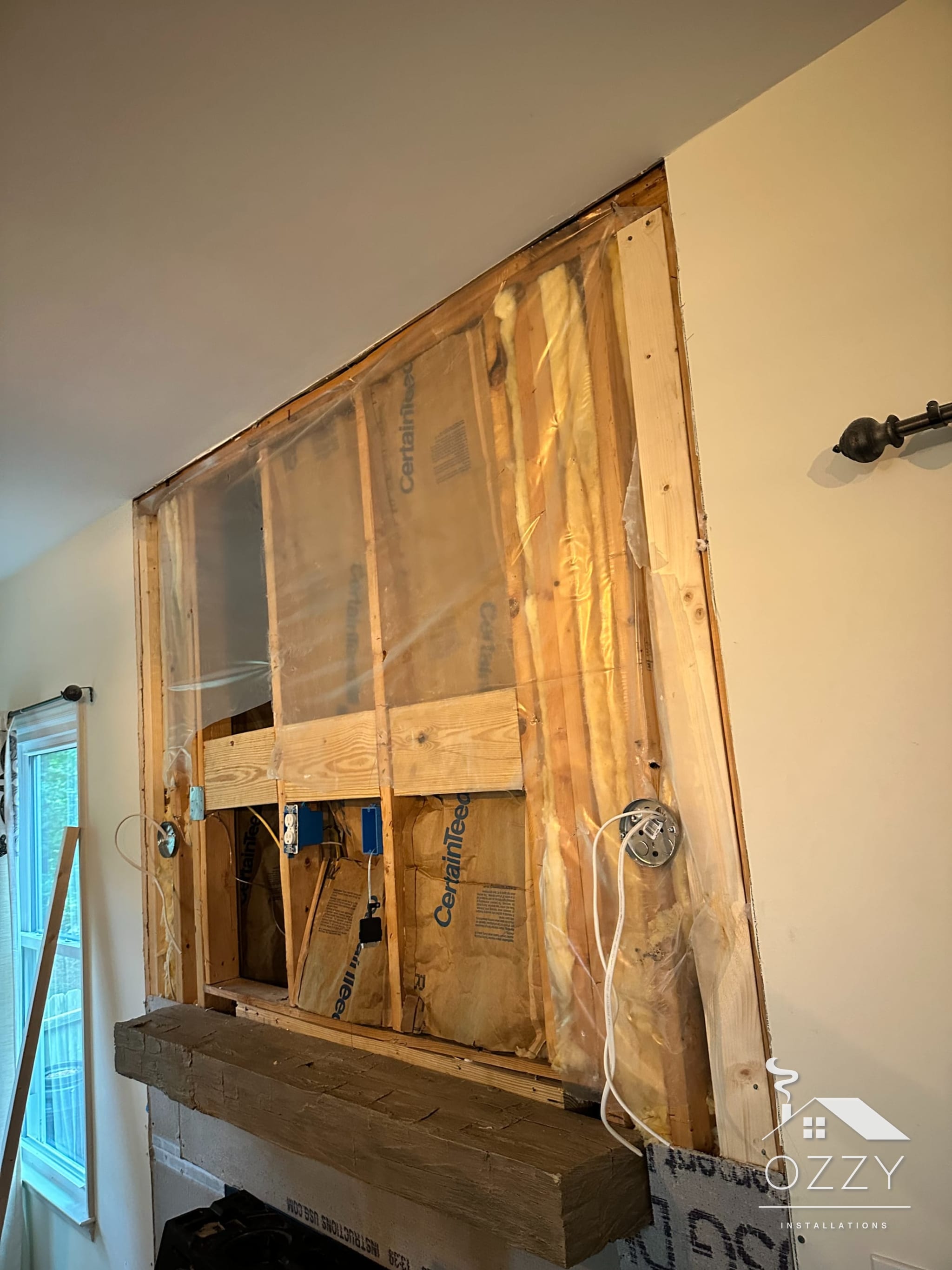 Fireplace wall opened down to the framing