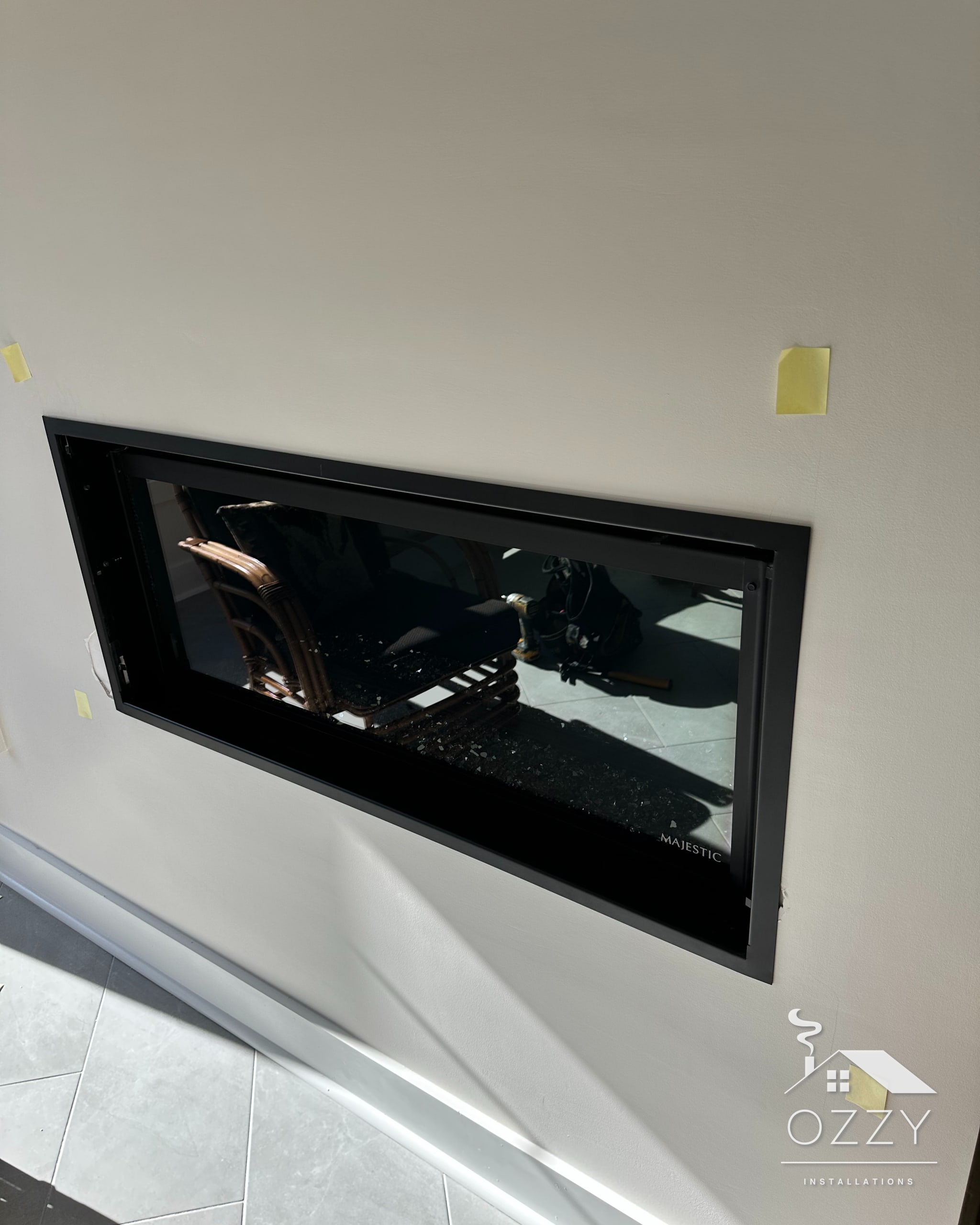 Linear fireplace set flush into a wall before the finish work
