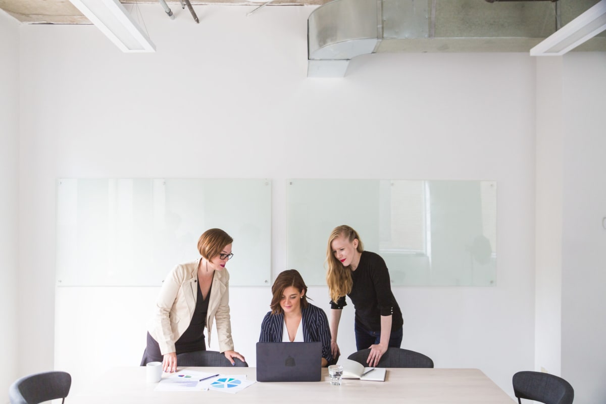 Wide view of three woman working in a modern office. Wide view of three woman working in a modern office.
