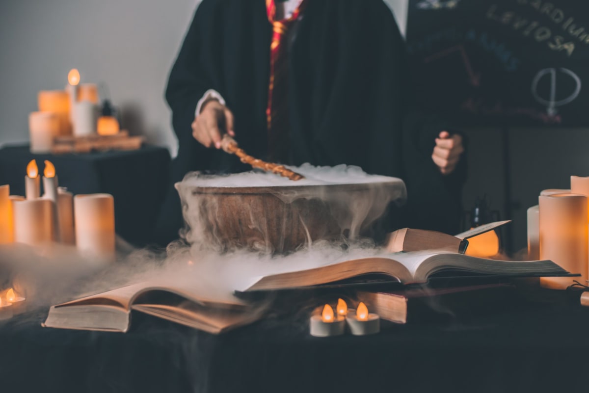 Picture of a table with multiple candles and cauldrons