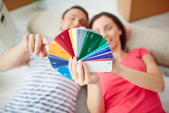 | Sohnne® Homeowner testing paint swatches on foam boards to find the perfect home decor color palette under different lighting conditions.