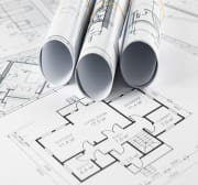 Premium Photo _ Architectural construction drawings twisted into a roll, construction projects on paper_.jpg