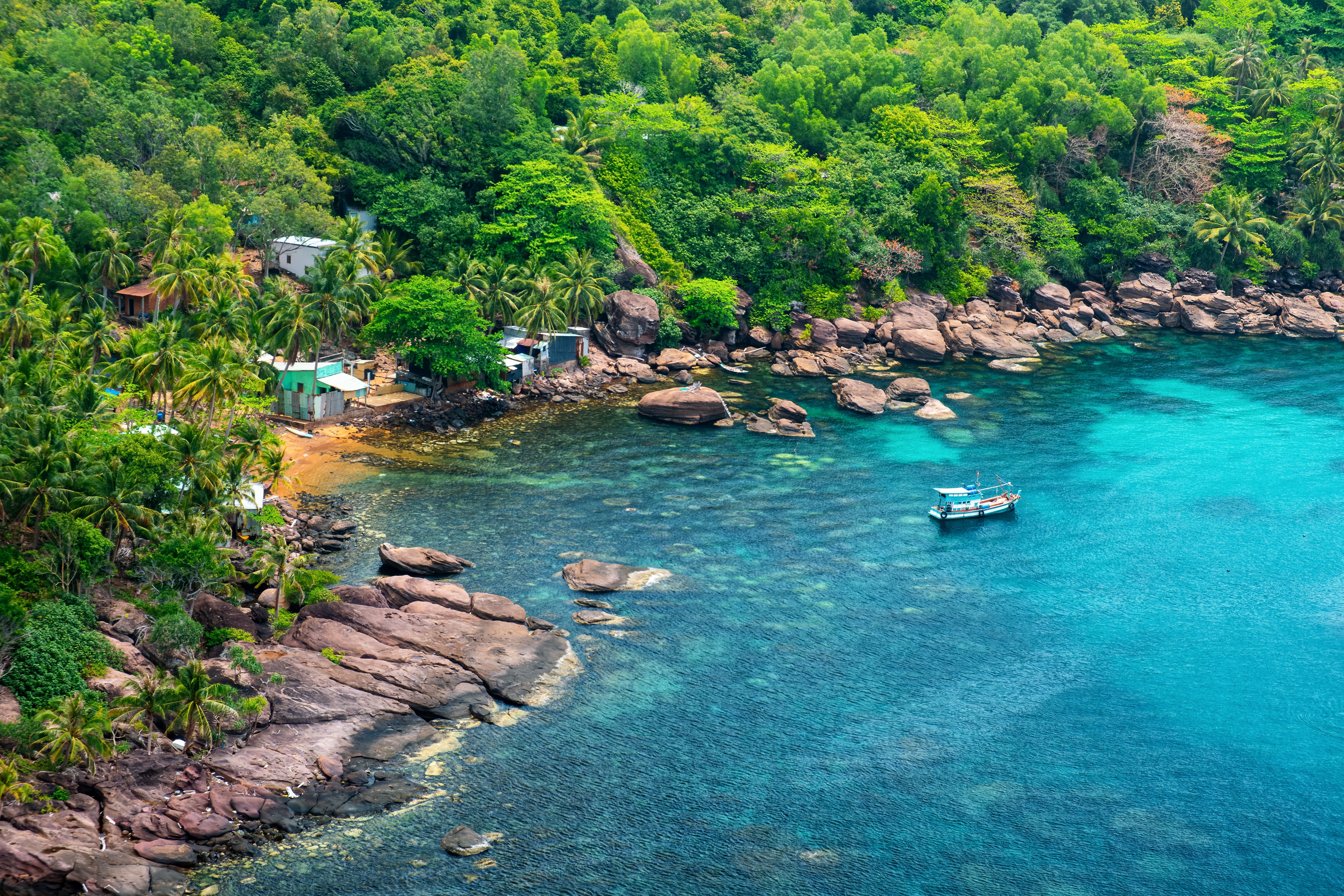 Explore hidden coves by kayak or bamboo boat