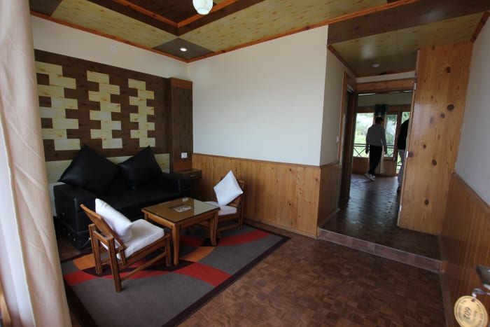 Seating area inside a room at Hilltop Resort Narkanda