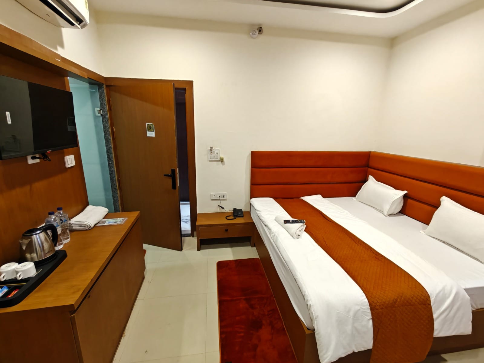 Room with LED TV, wardrobe and tea and coffee tray at Hotel Grand Lucent